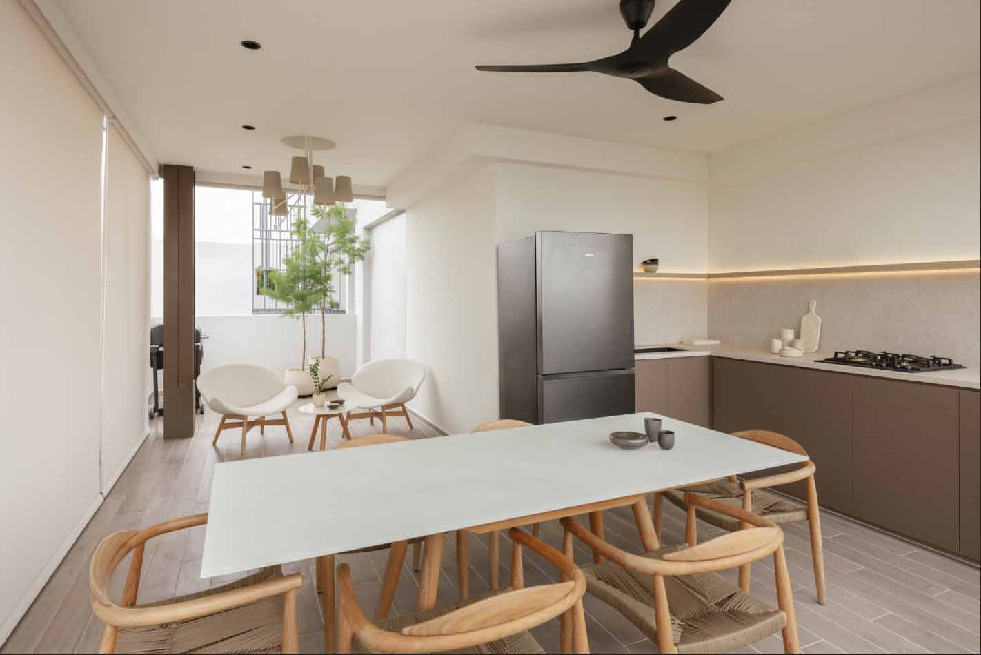 The once-bare roof terrace now houses a comfortable outdoor kitchen and dining area for the Serangoon penthouse's extended family gatherings