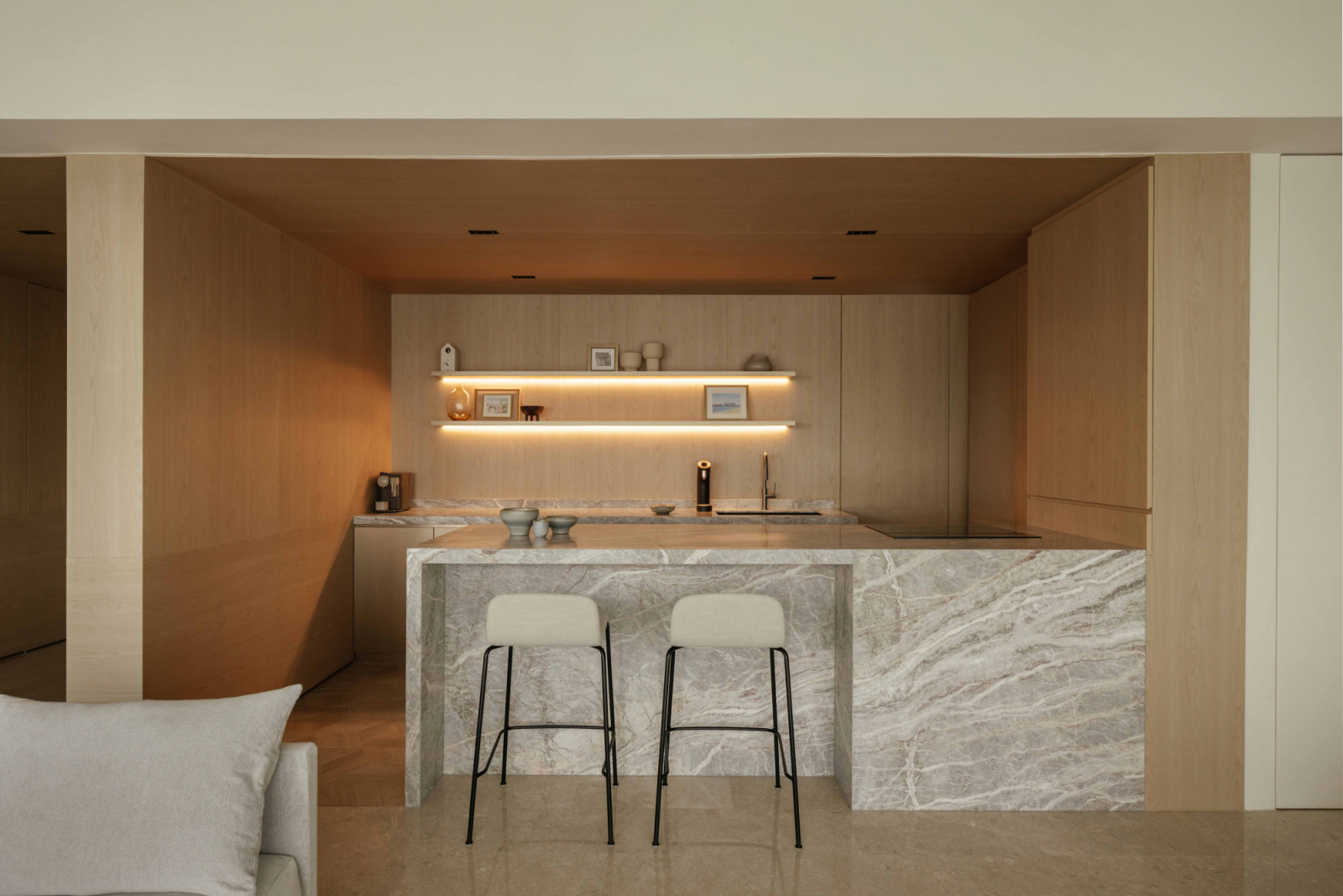 The dry kitchen's Fiore di Pesco marble island anchors the heart of the penthouse