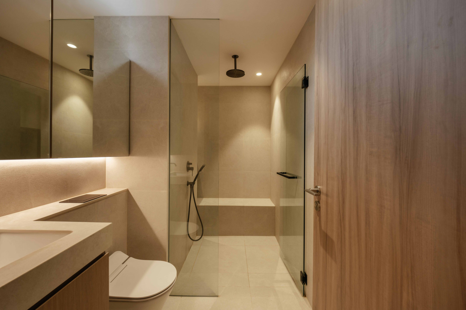 A glass-enclosed shower replaces the original bathtub for a more usable layout
