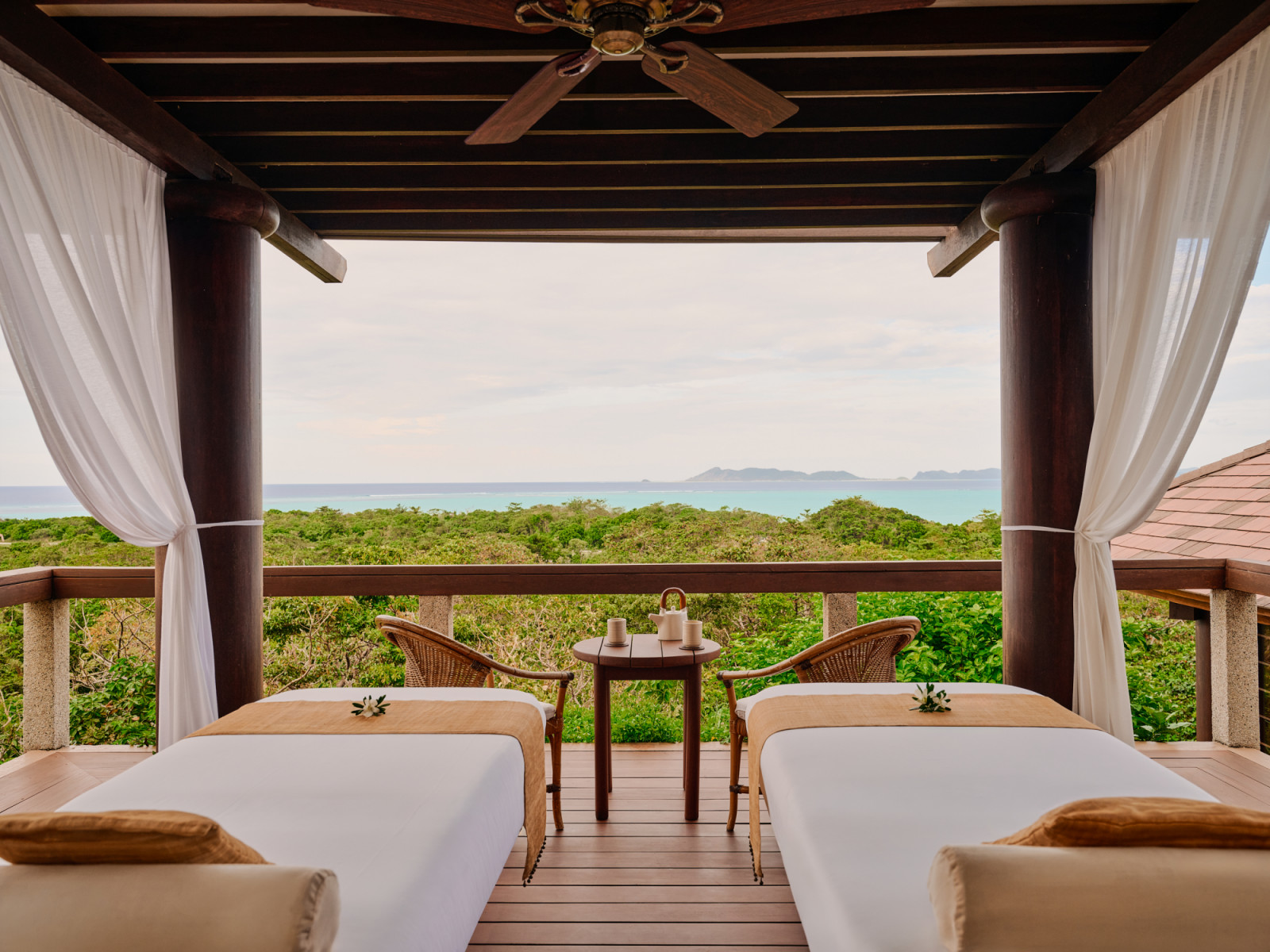 Amanpulo's open-air spa pavilion provides serene massage treatments overlooking the turquoise ocean.