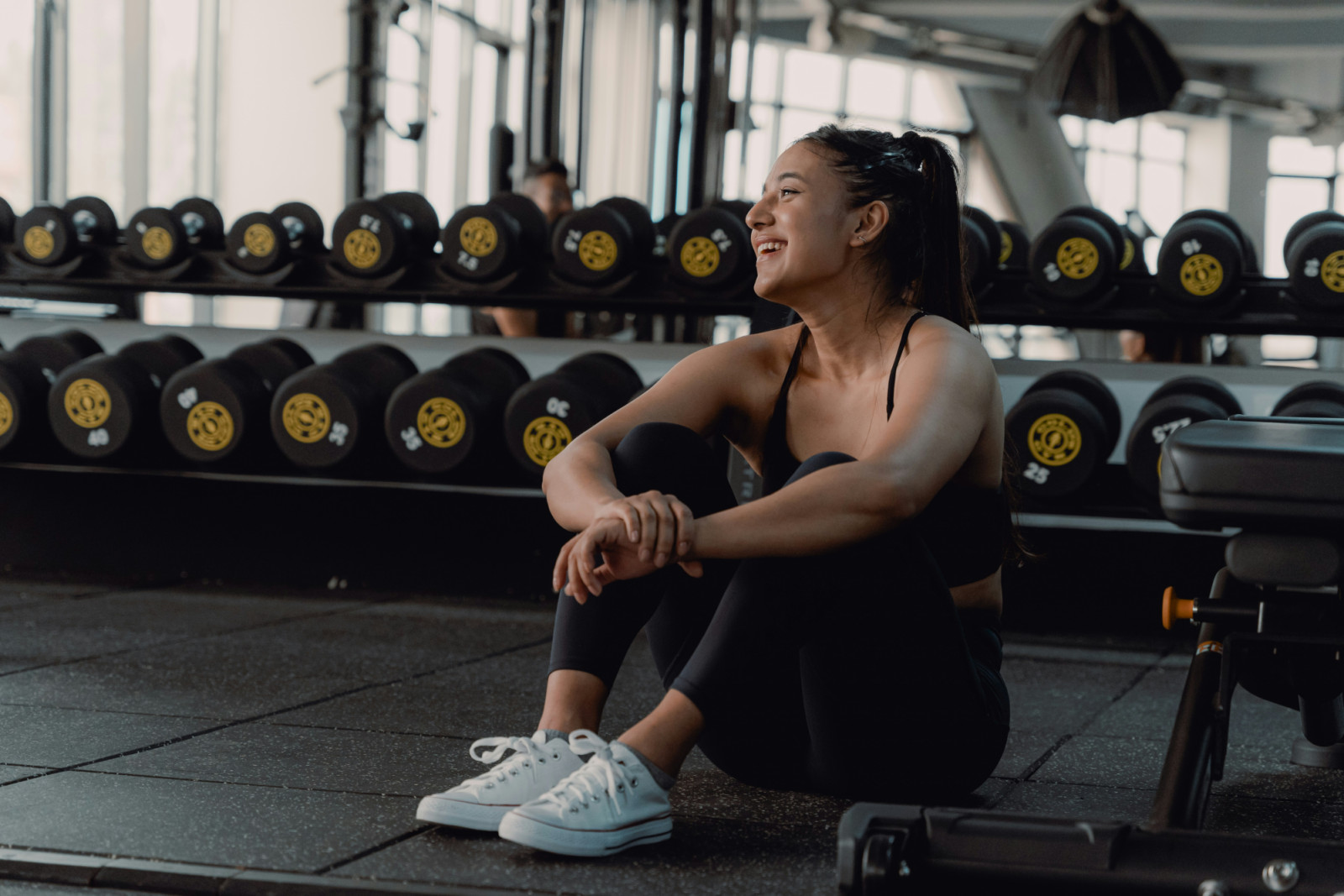 woman sitting on a gym floor: Could less exercise make you more fit? (Photo: Gold’s Gym Nepal/ Unsplash)