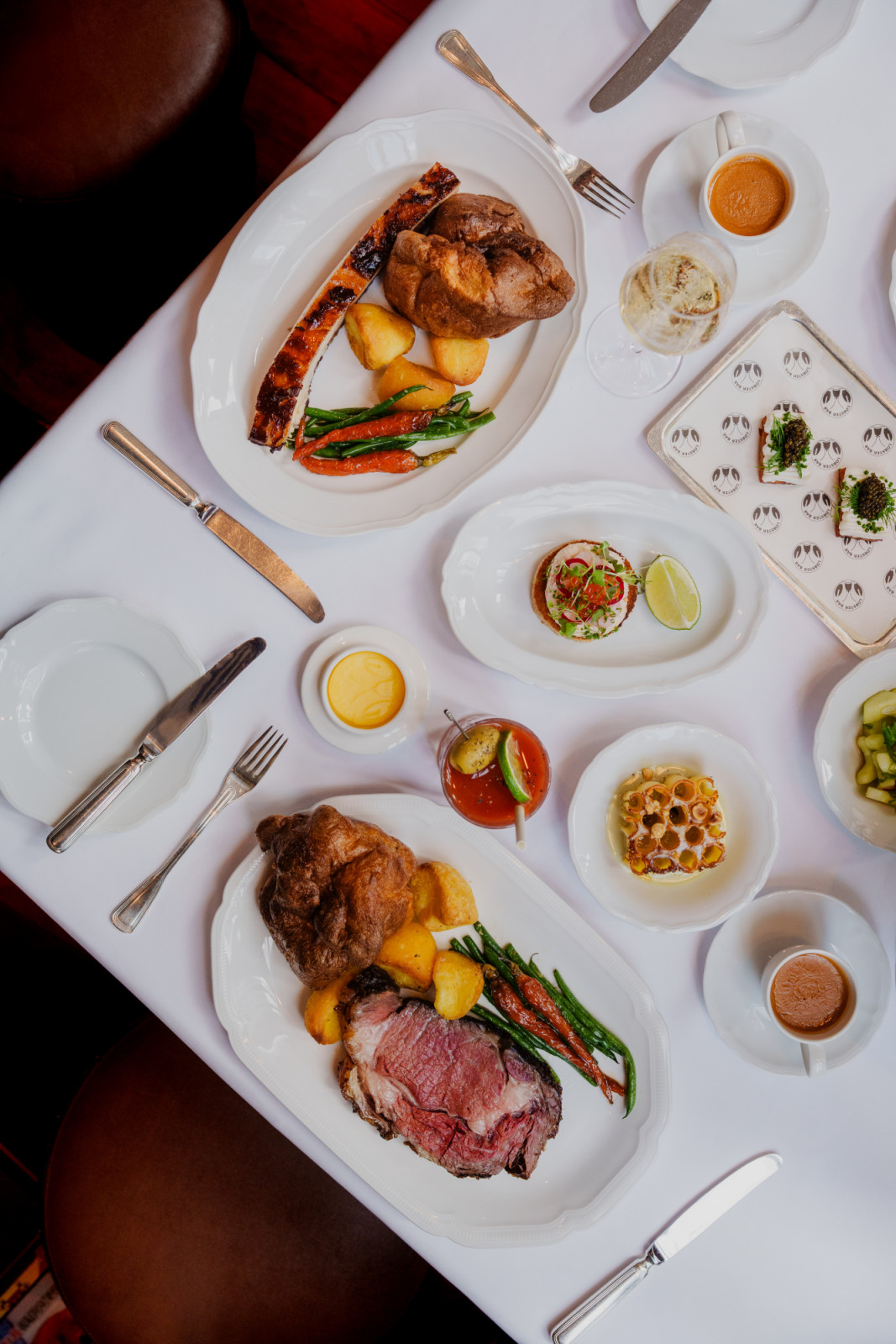 Lobster Bar offers a multi-course dining experience with roasted prime rib, Yorkshire puddings, and caviar toast.