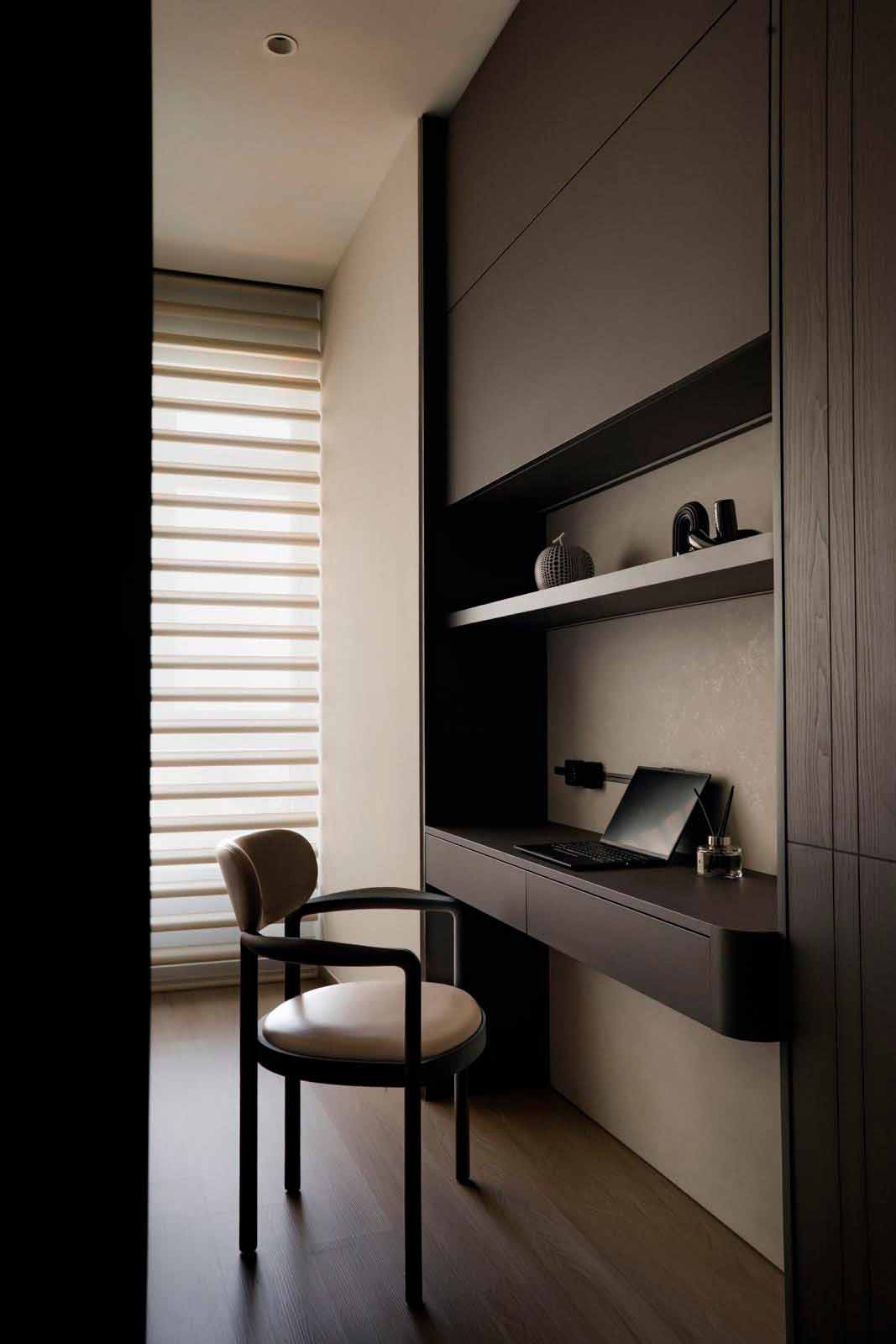 A streamlined study nook is set into full-height cabinetry;