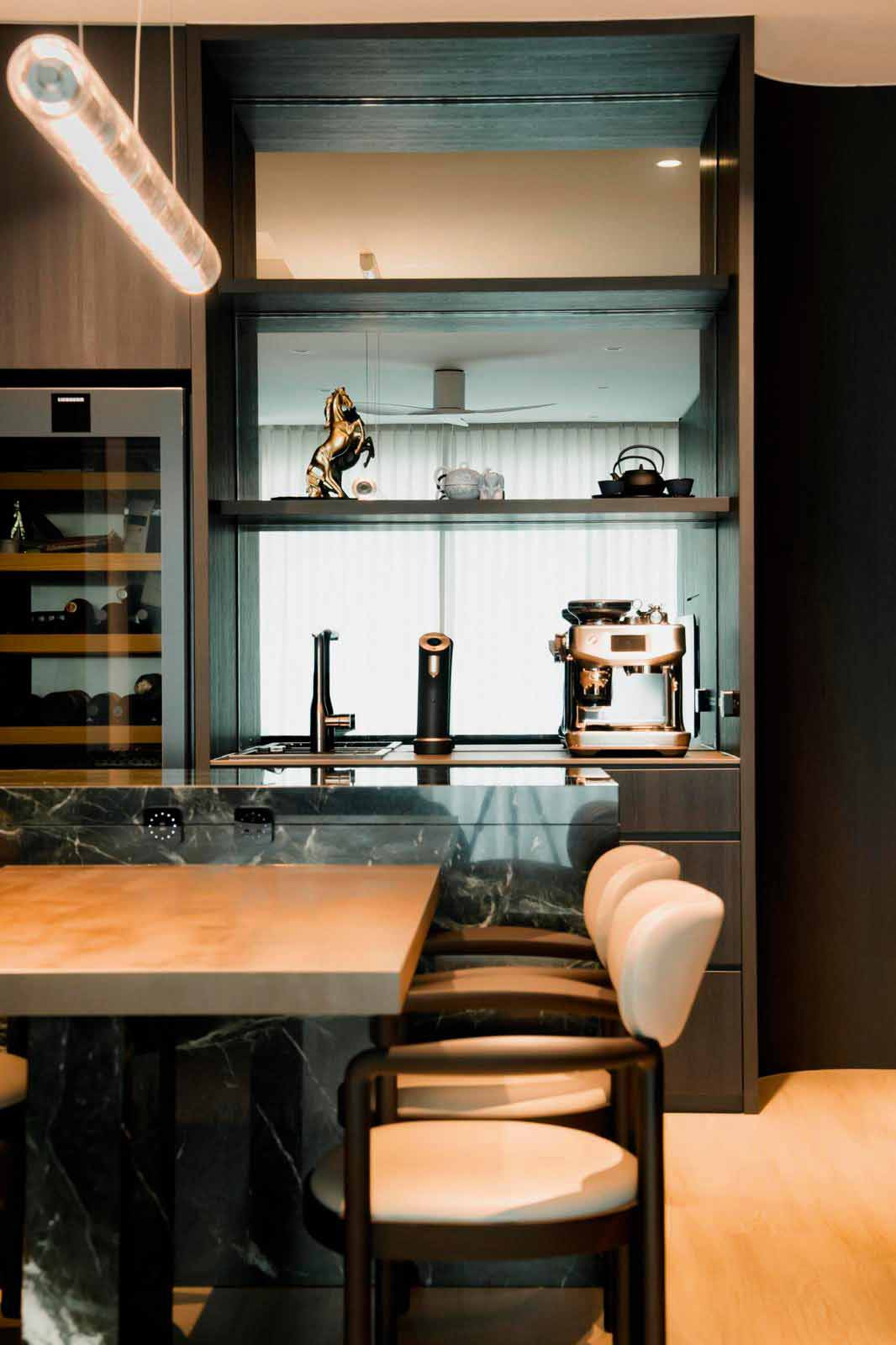 The dry pantry doubles as a display and coffee station, set against mirrored backing