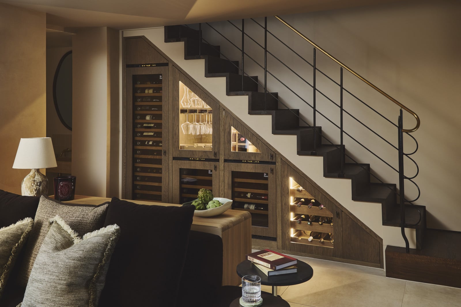 The wine refrigerators beneath the stairs of a Notting Hill home by Project London