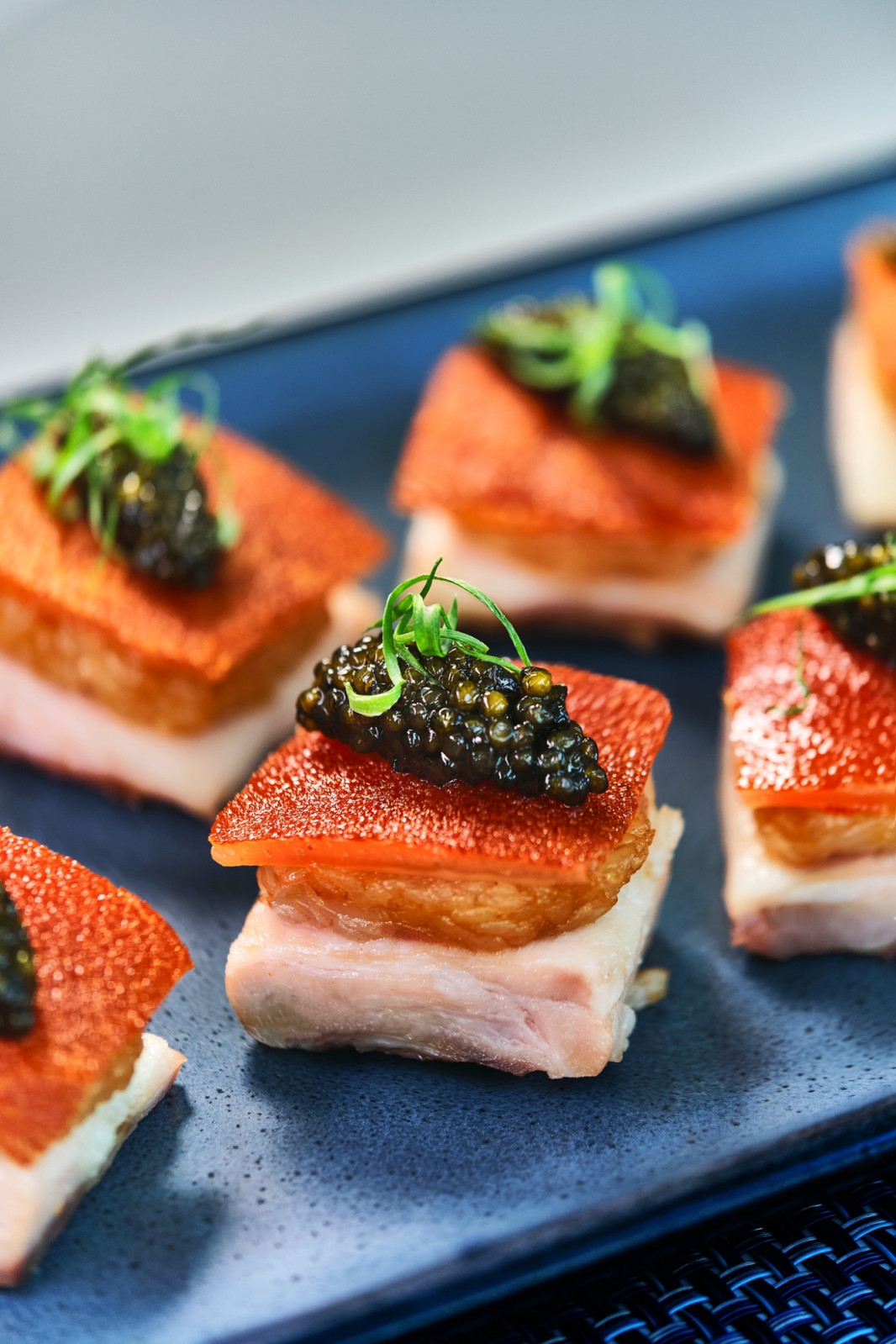 A refined dish of crispy roast pork belly crowned with caviar by Harbourside.