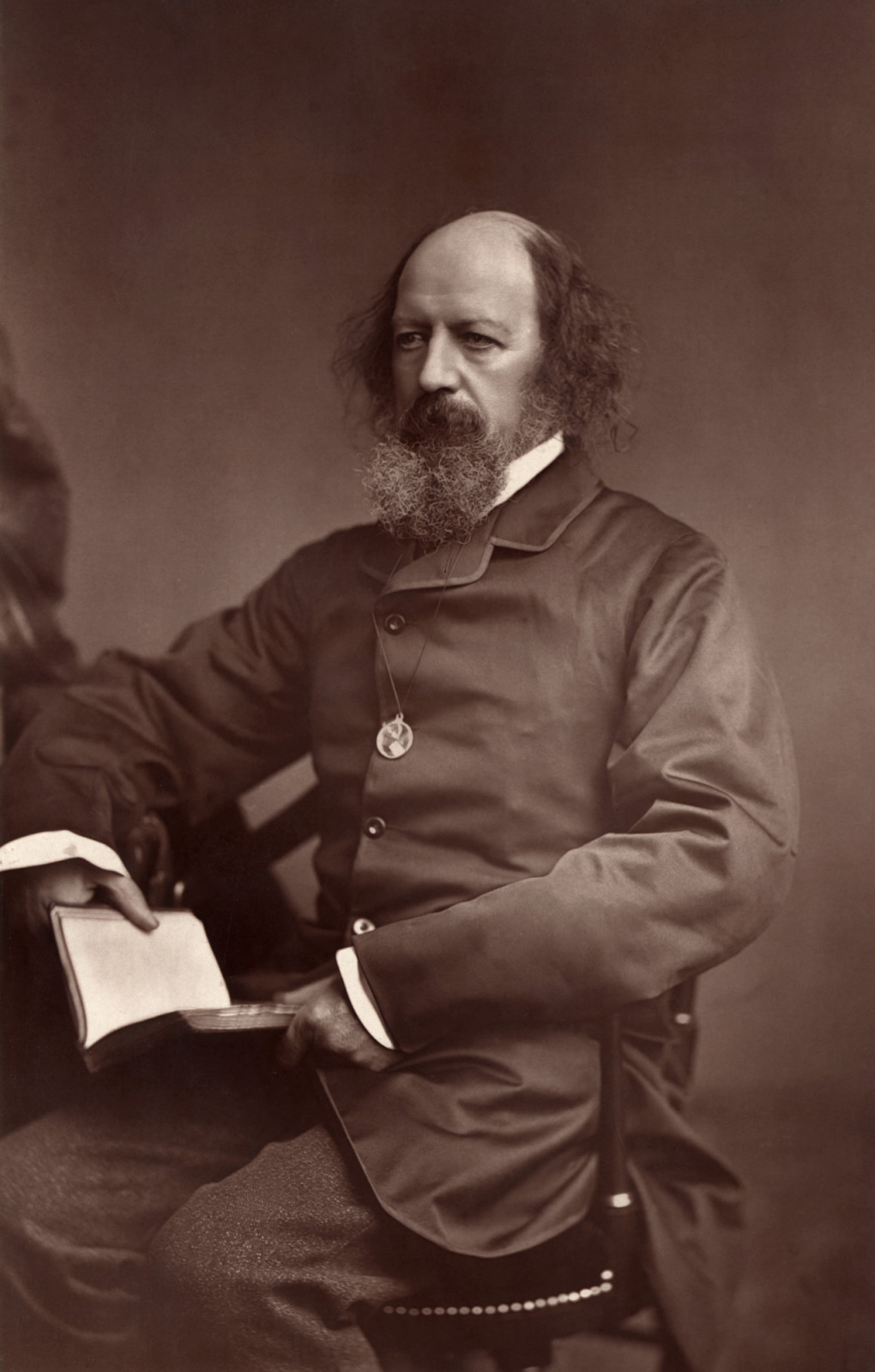 Alfred, Lord Tennyson, the influential Victorian poet, is pictured holding a book.