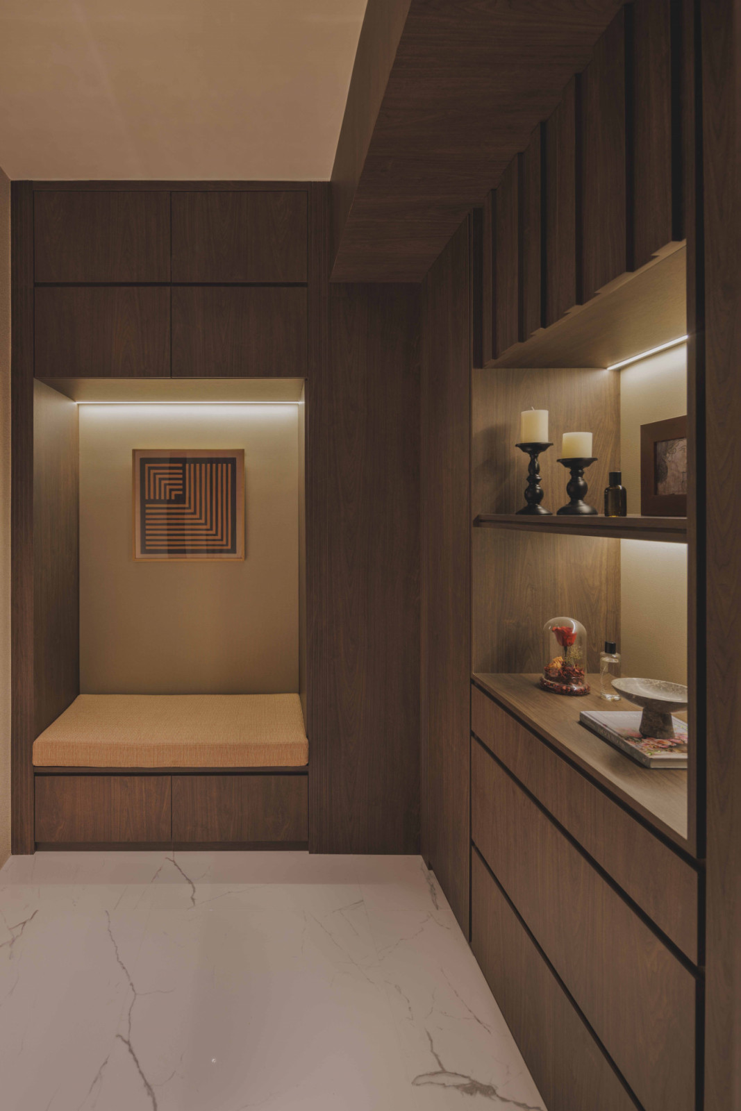 The entryway, featuring a cushioned bench, quickly dissolves into the living room