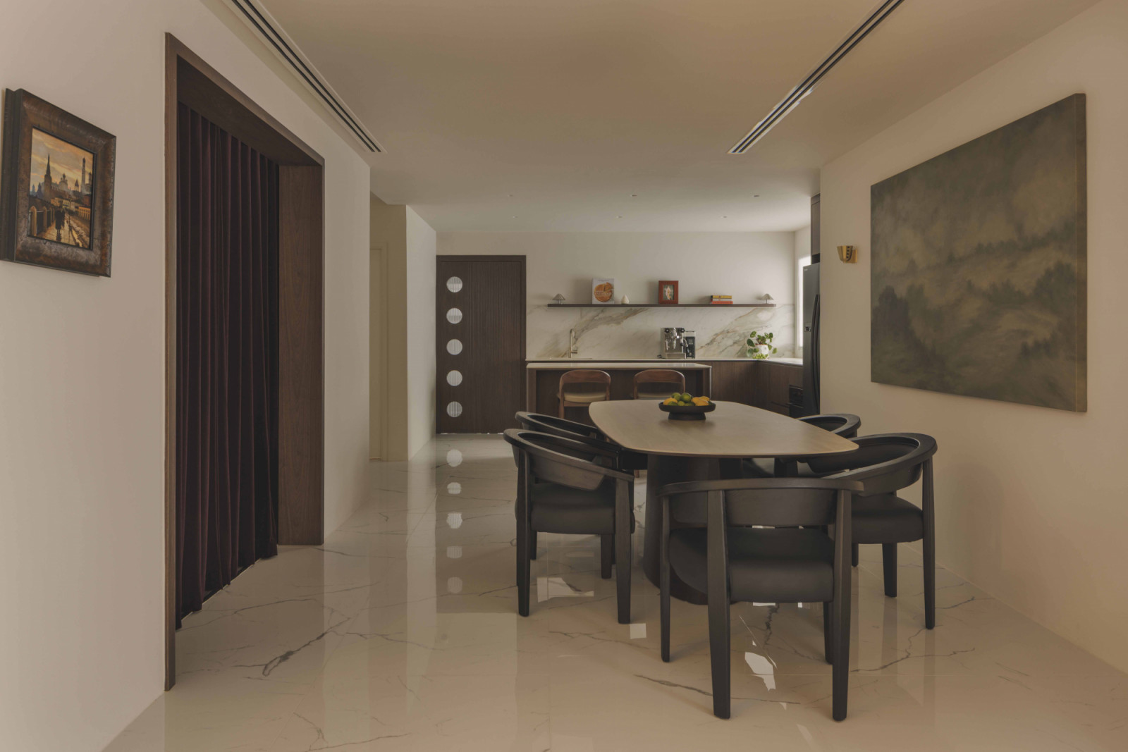 To the left of the dining table is a hidden bar designed for the owners, who love to entertain