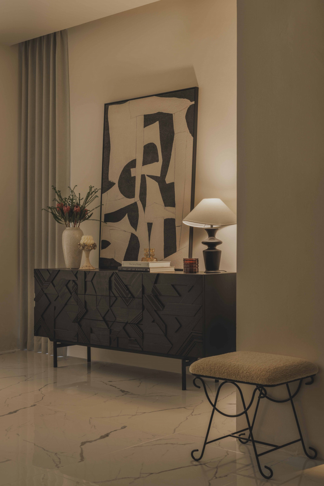 A dark timber media console in the living room holds more decorative objects