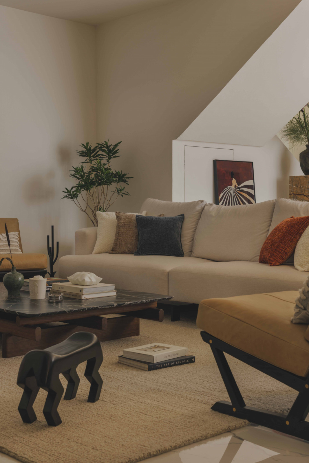 A cream sectional sofa holds court in the living room, bouyed by pops of colour in the form of loose furniture