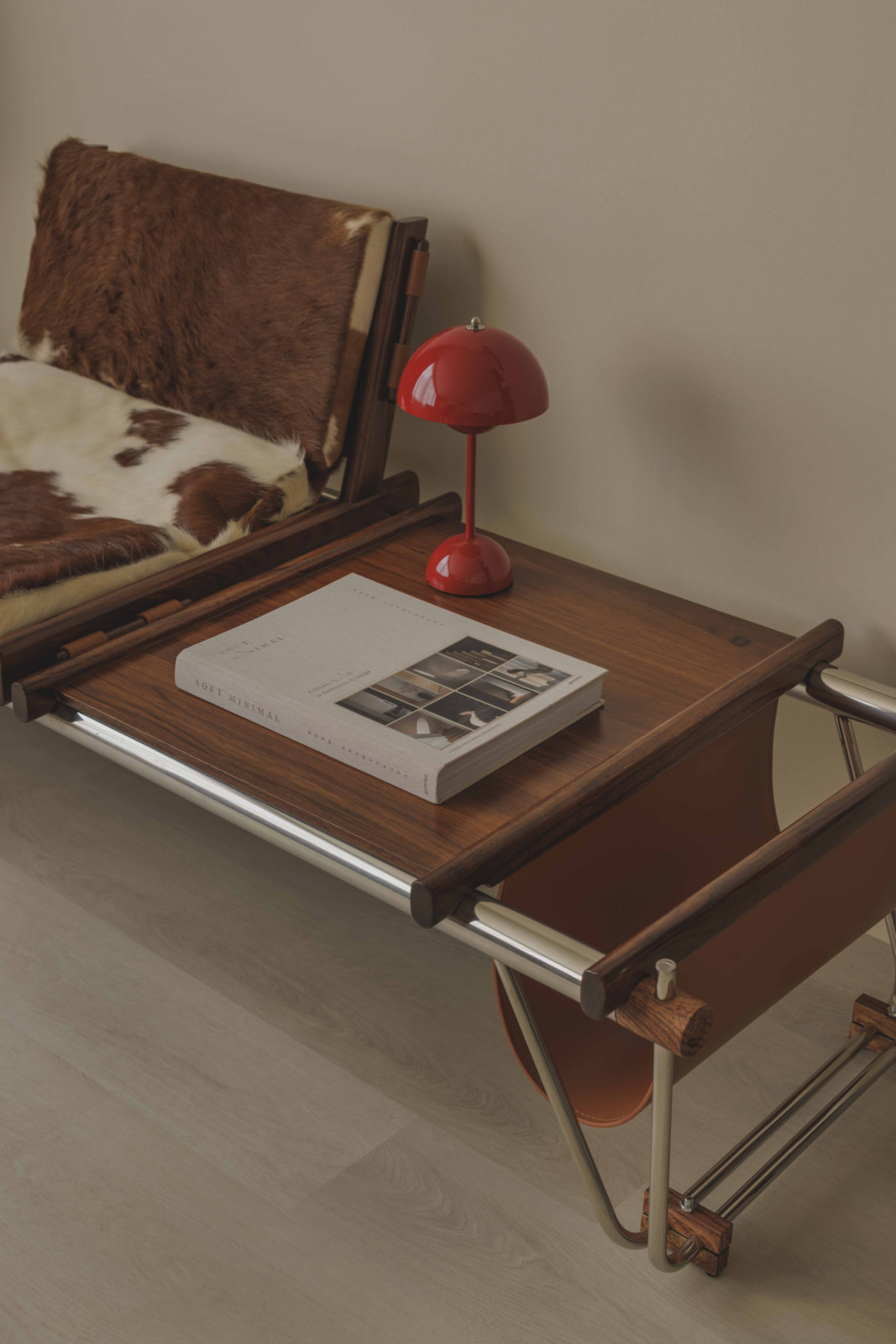 A red Verner Panton Flowerpot lamp proudly stands out amidst caramel tones