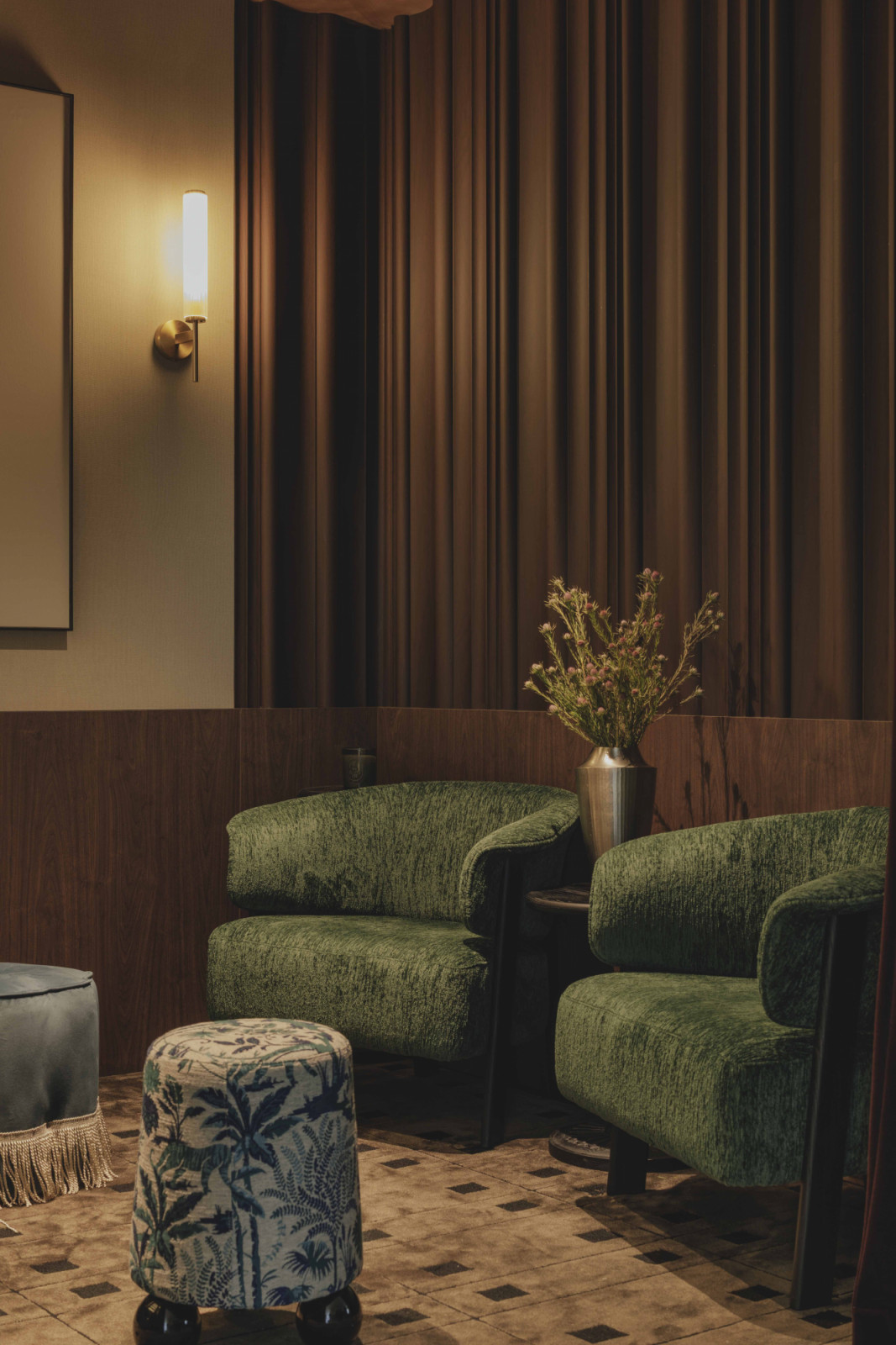Inside the bar, dark timber panelling and low, warm lighting transforms the space into a bespoke speakeasy