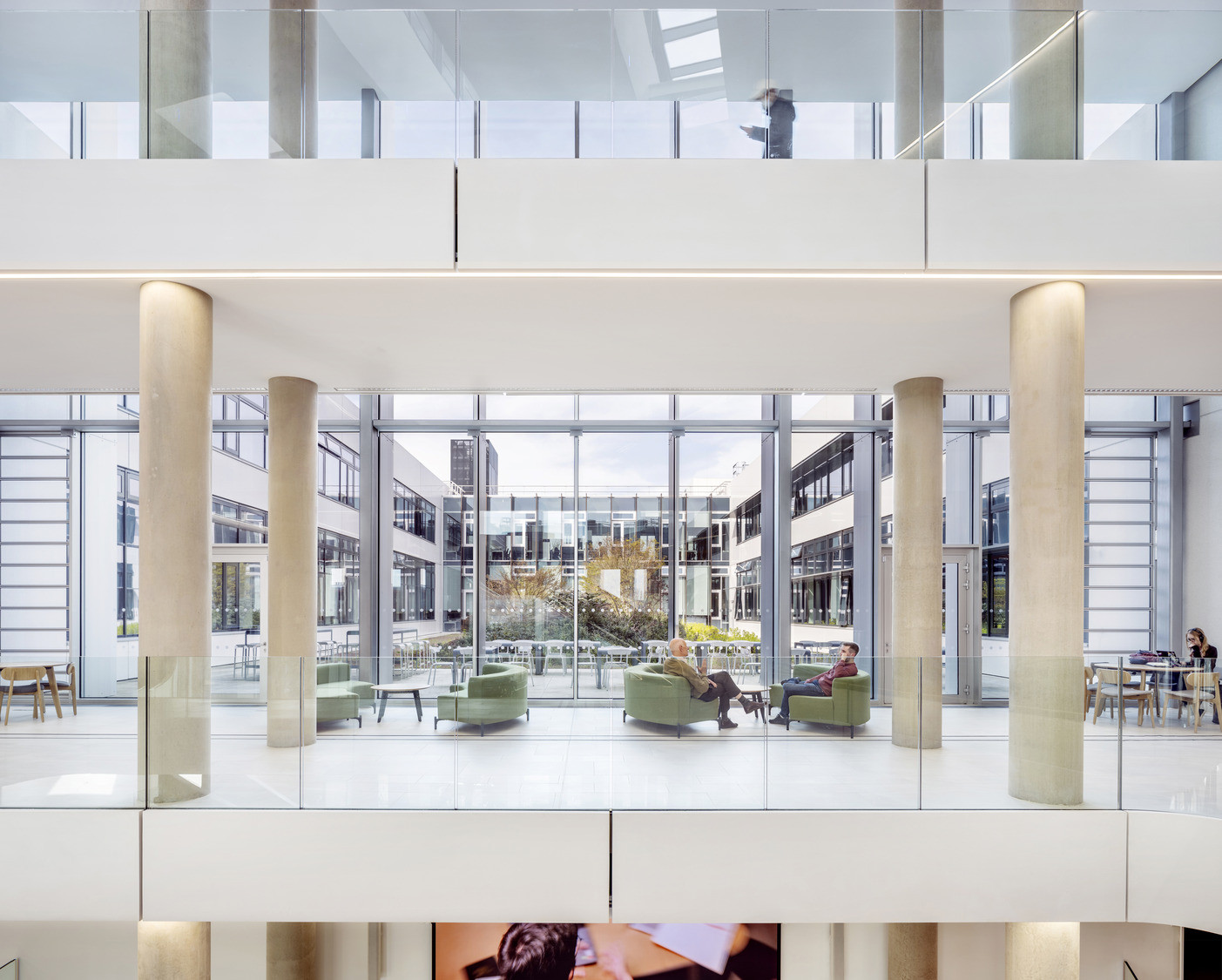 Green upholstered armchairs face floor-to-ceiling glazing overlooking an internal courtyard shared with neighbouring science buildings (Photo: Kilian O’Sullivan)