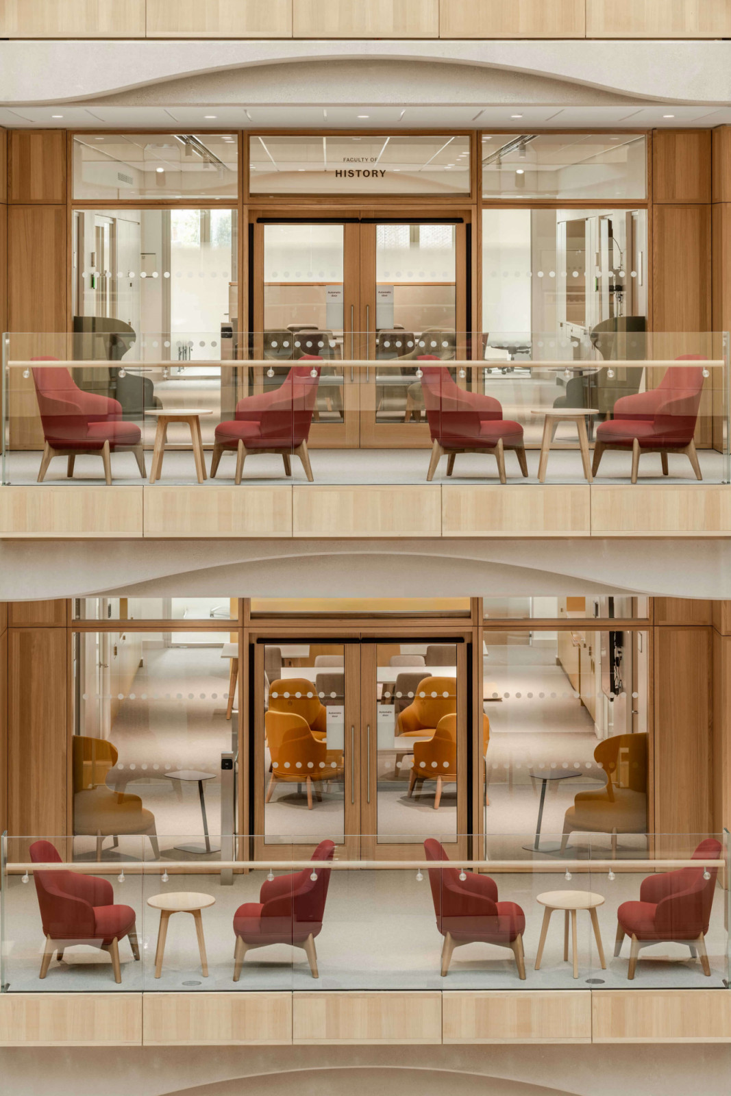 Stacked balconies mark the entrance to the Faculty of History, with red and ochre armchairs arranged in pairs along the oak-lined façade (Photo: Hufton + Crow)