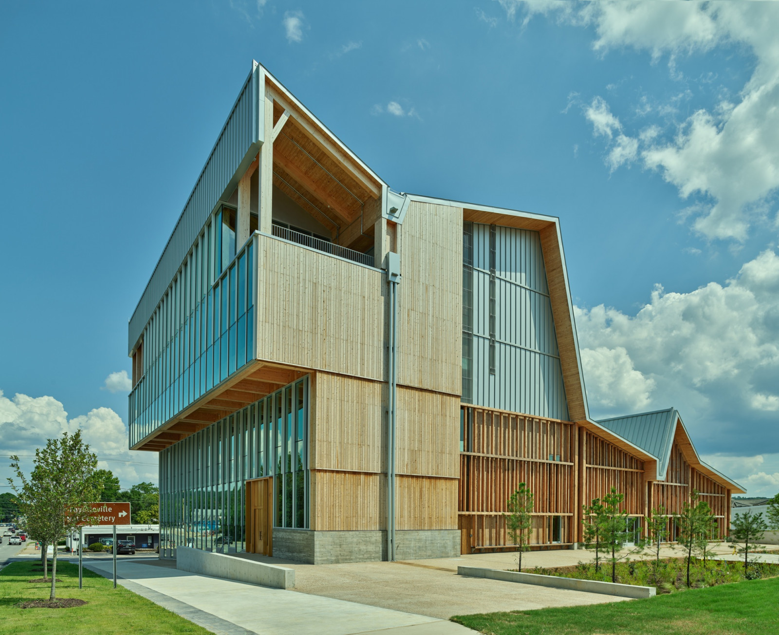 The building's roofline breaks into a jagged sequence of gables, each clad in standing-seam metal above timber-slatted walls (Photo: Timothy Hursley)