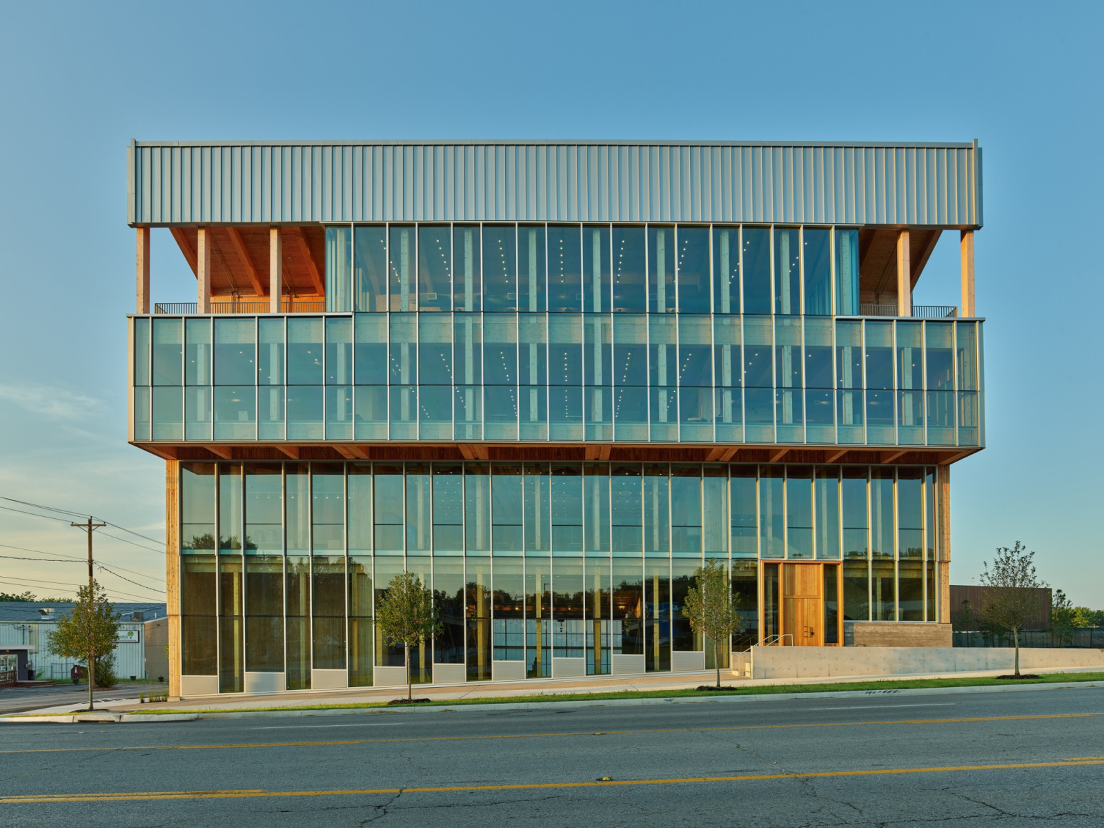 Glazed floors stack above a cantilevered ground level, with exposed timber columns supporting the roof’s overhanging edge (Photo: Timothy Hursley)