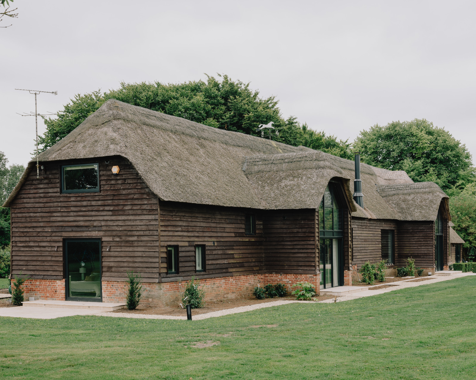 The exterior of a renovated barn home in Wiltshire, England by Munro