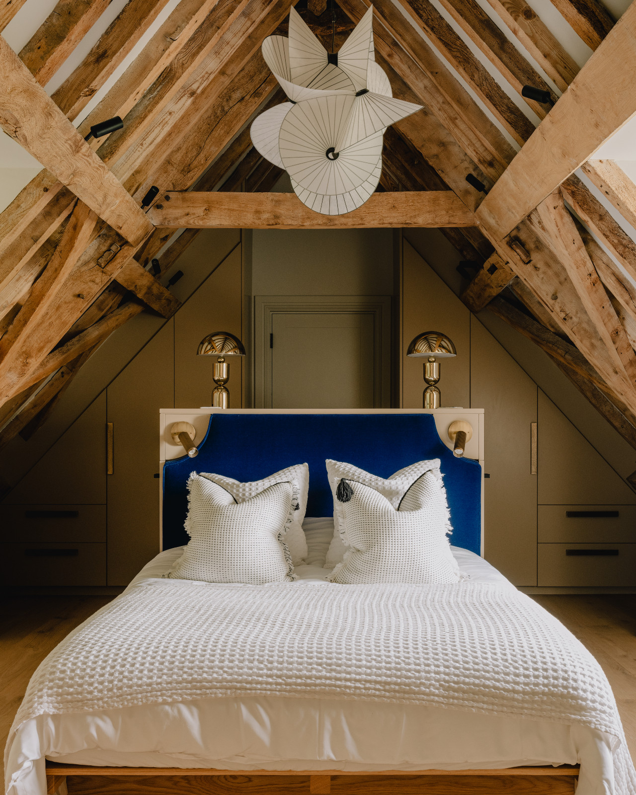 The bedroom of a renovated barn home in Wiltshire, England by Munro