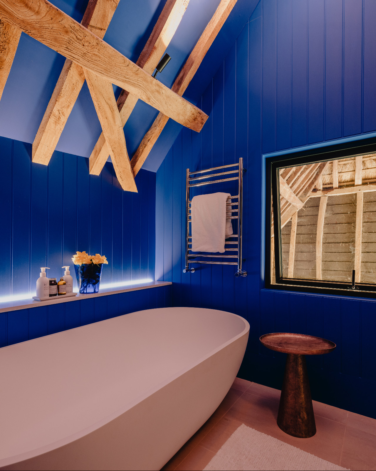 The bathroom of a renovated barn home in Wiltshire, England by Munro