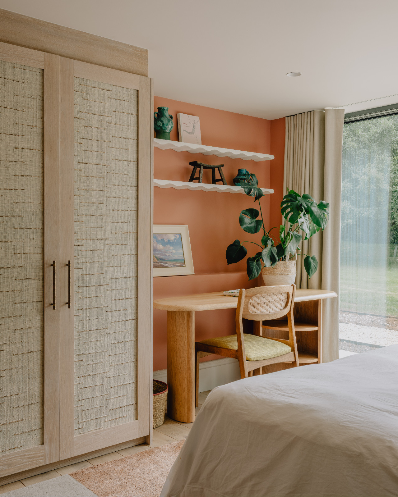 The guest bedroom of a renovated barn home in Wiltshire, England by Munro