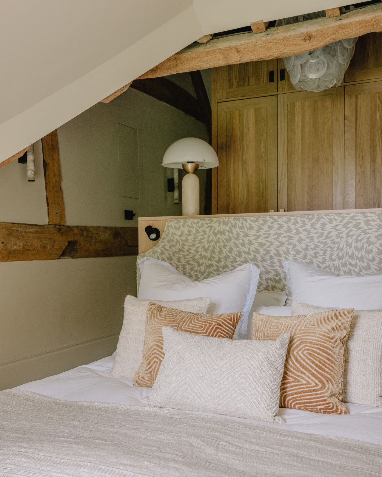 The guest bedroom of a renovated barn home in Wiltshire, England by Munro