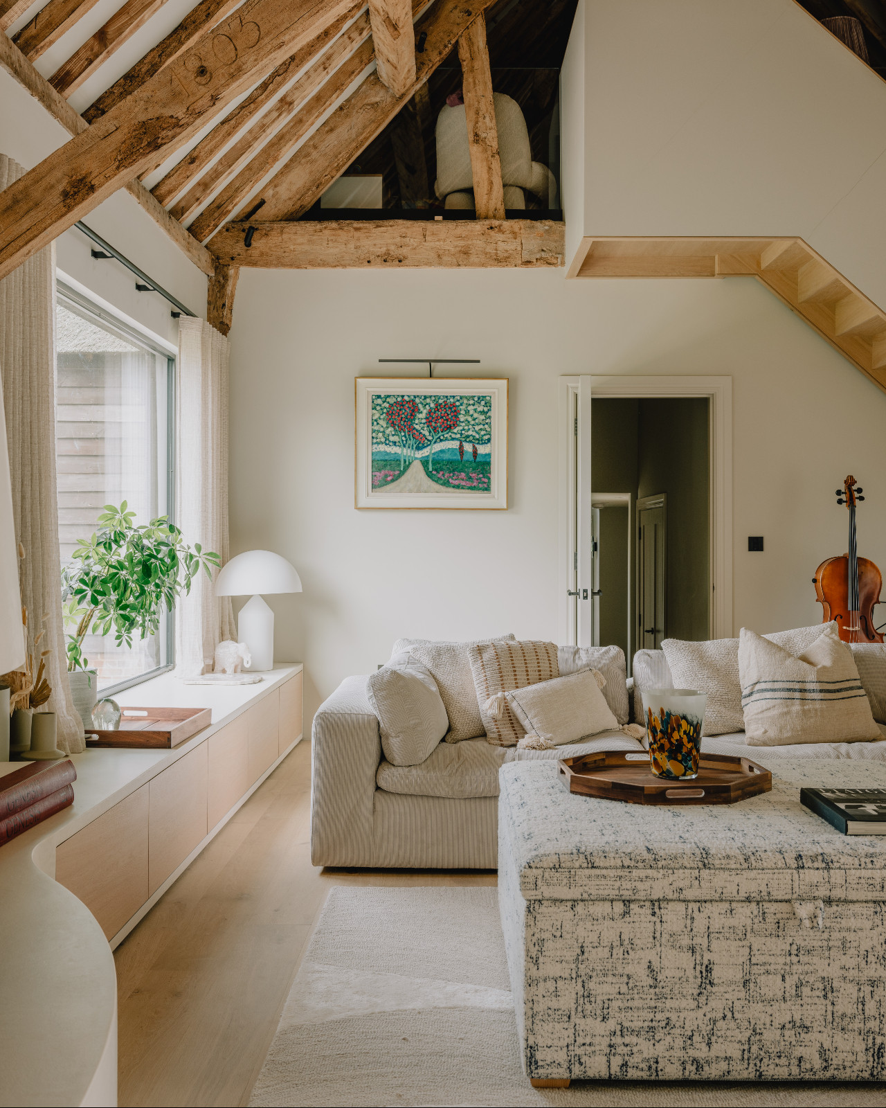 The living room of a renovated barn home in Wiltshire, England by Munro