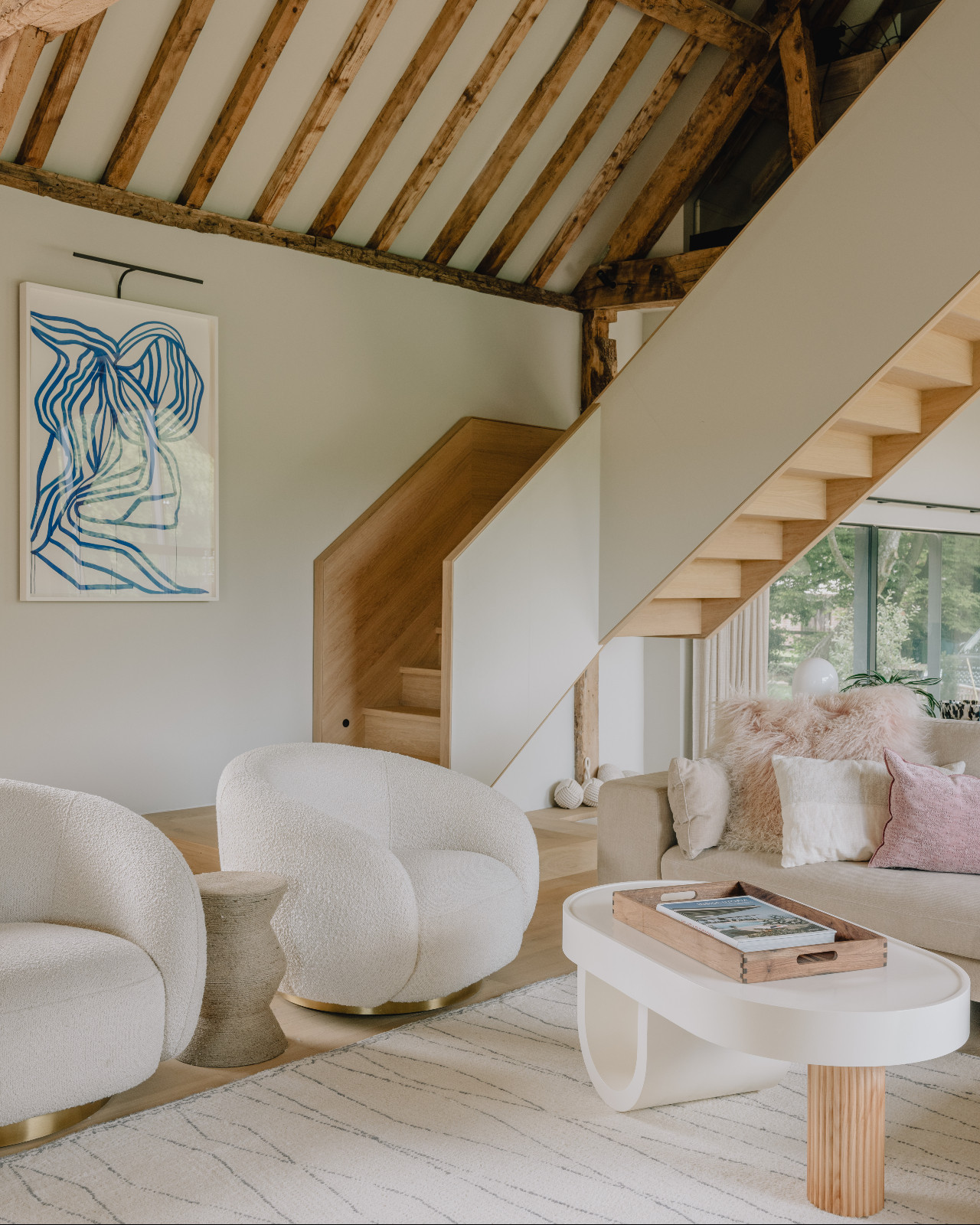 The living room of a renovated barn home in Wiltshire, England by Munro