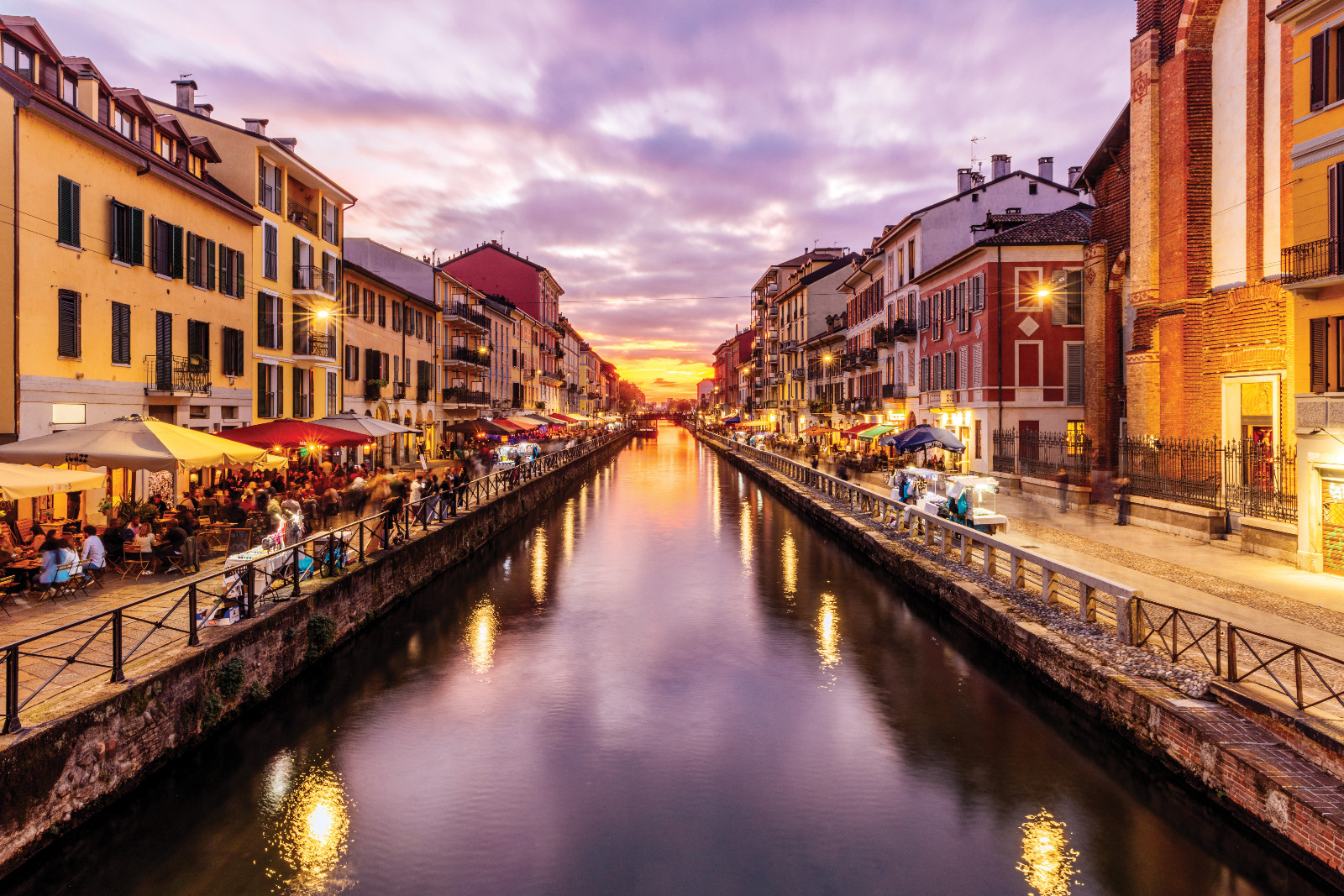 The Naviglio Grande in Milan glows at sunset, its bustling canalside perfect for an aperitivo or quiet contemplation. (Photo from Getty Images)