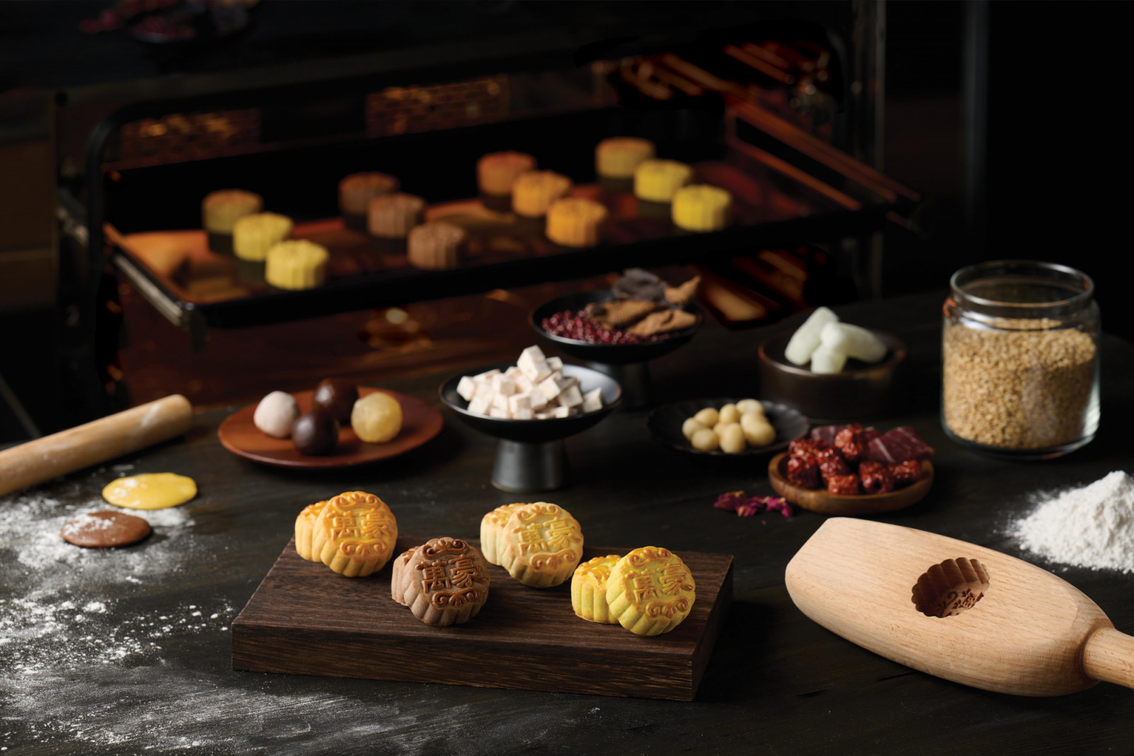 A display of freshly baked mooncakes and raw ingredients highlights the traditional artistry of crafting these seasonal delicacies.