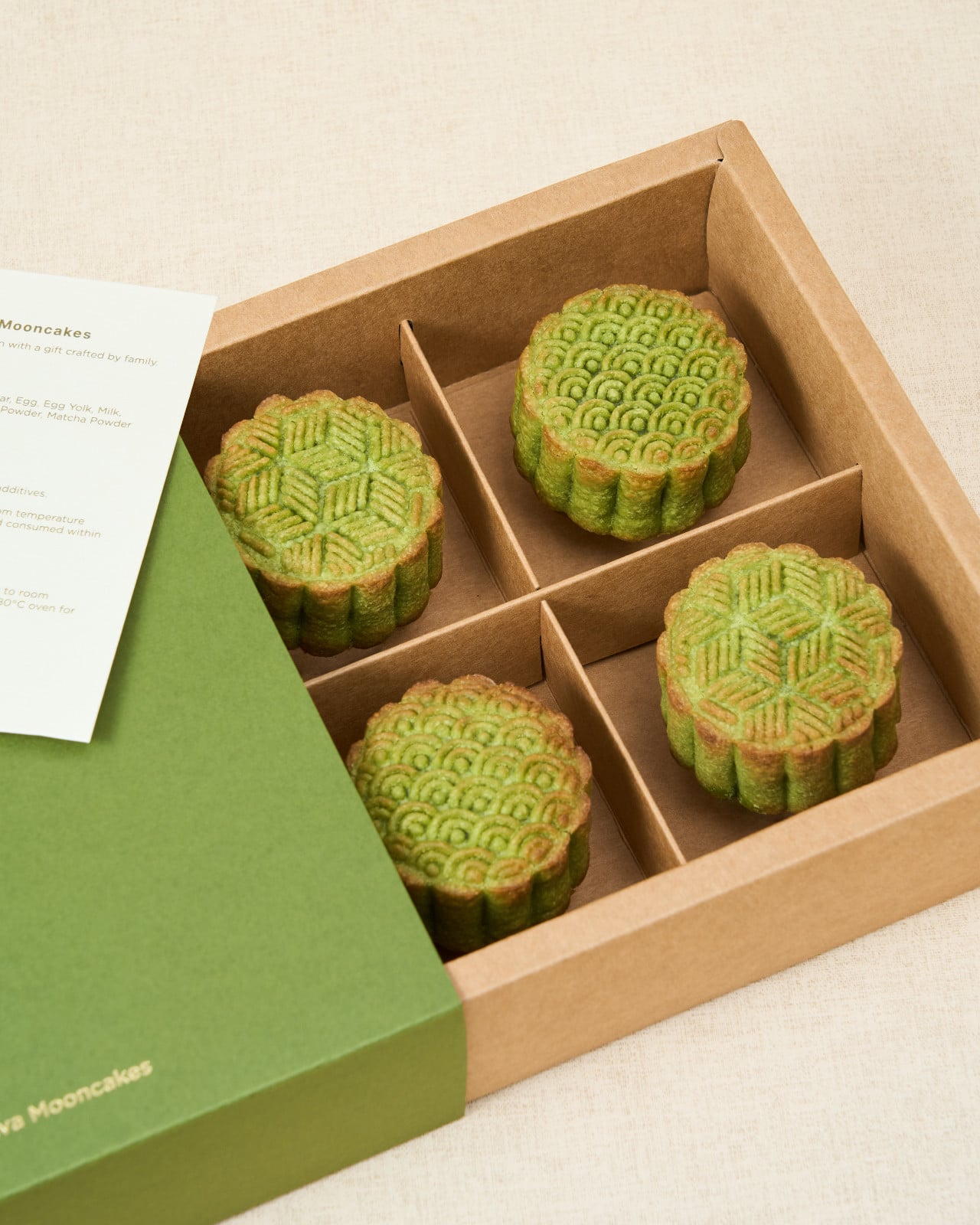 Matcha mooncakes by Ava Mooncakes, elegantly presented in a brown gift box.
