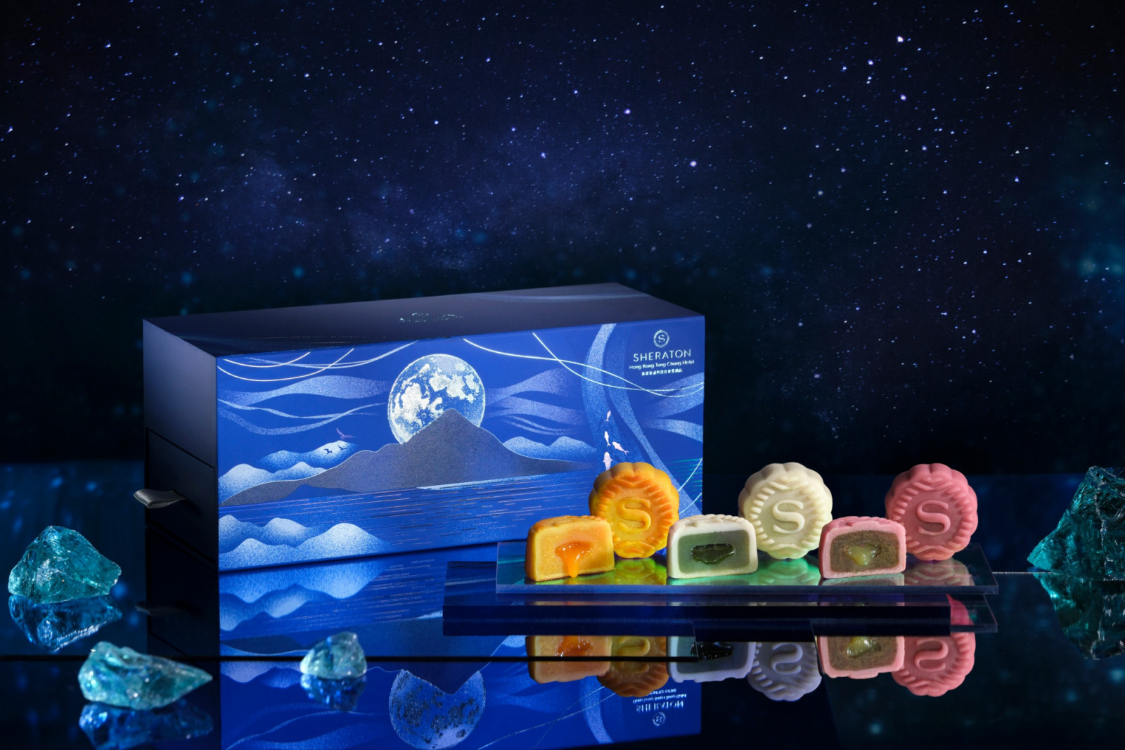 Sheraton Hong Kong Tung Chung Hotel's mooncakes, showcasing various vibrant flavors, presented with their elegant, celestial-themed gift box.