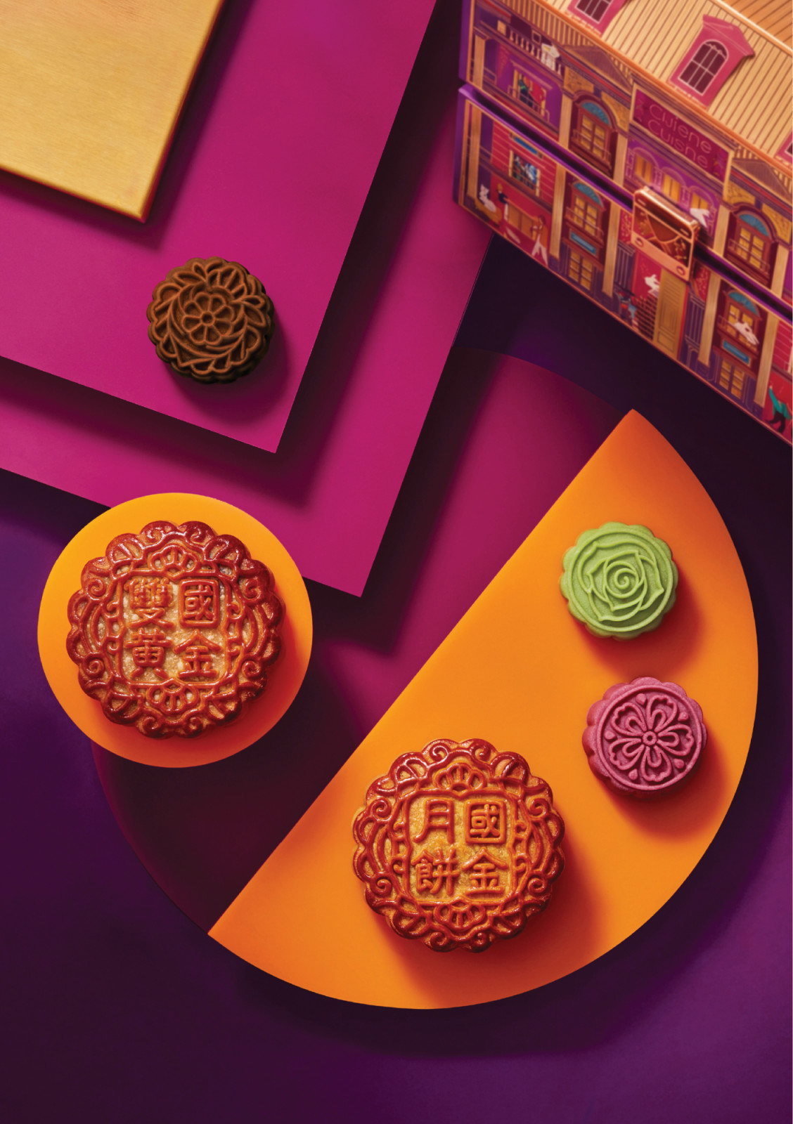 Cuisine Cuisine mooncakes showcase traditional characters and intricate floral patterns, presented with their distinctive house-shaped gift box.
