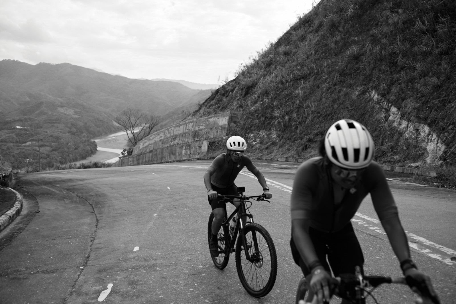 Two cyclists ascend a winding mountain road. (Photo by Francisco "Paco" Guerrero)