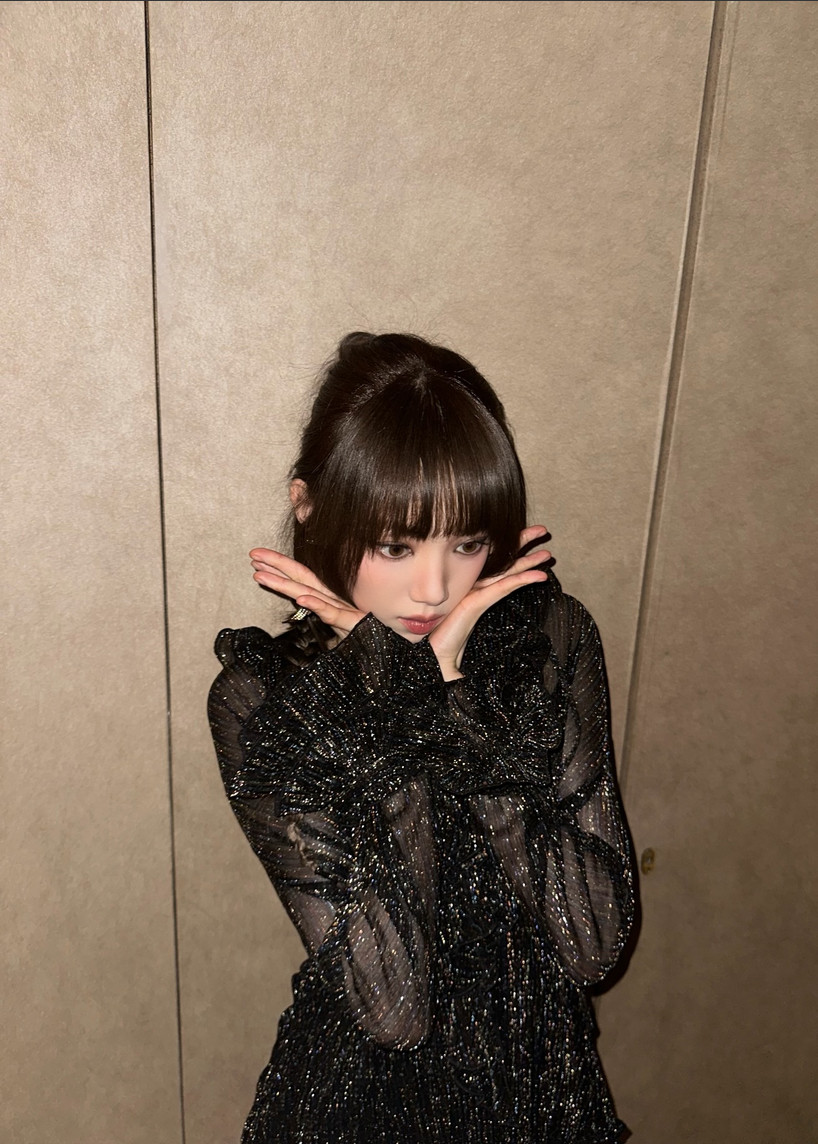 Actress and model Lee Sung-kyung embodies chic sophistication in a shimmering black top.