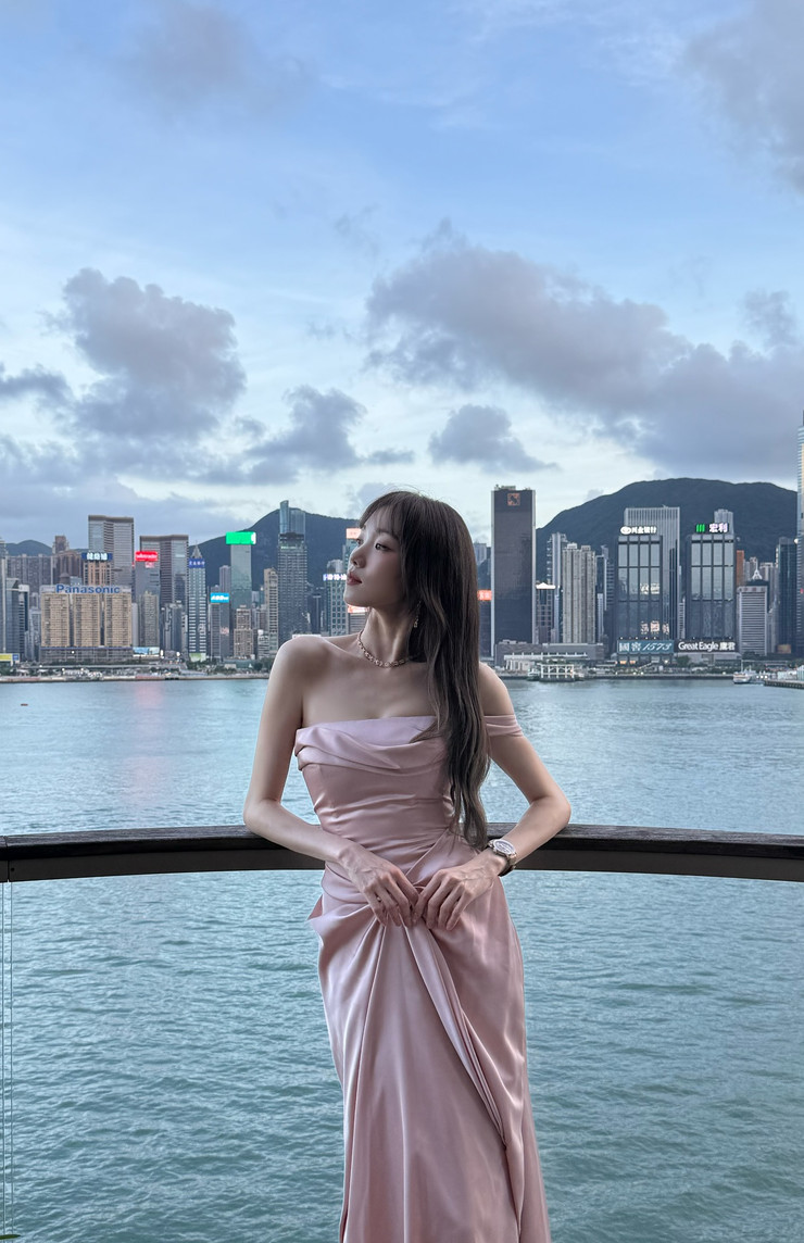 Lee Sung-kyung showcases her style in a draped pink gown overlooking Hong Kong's Victoria Harbour.