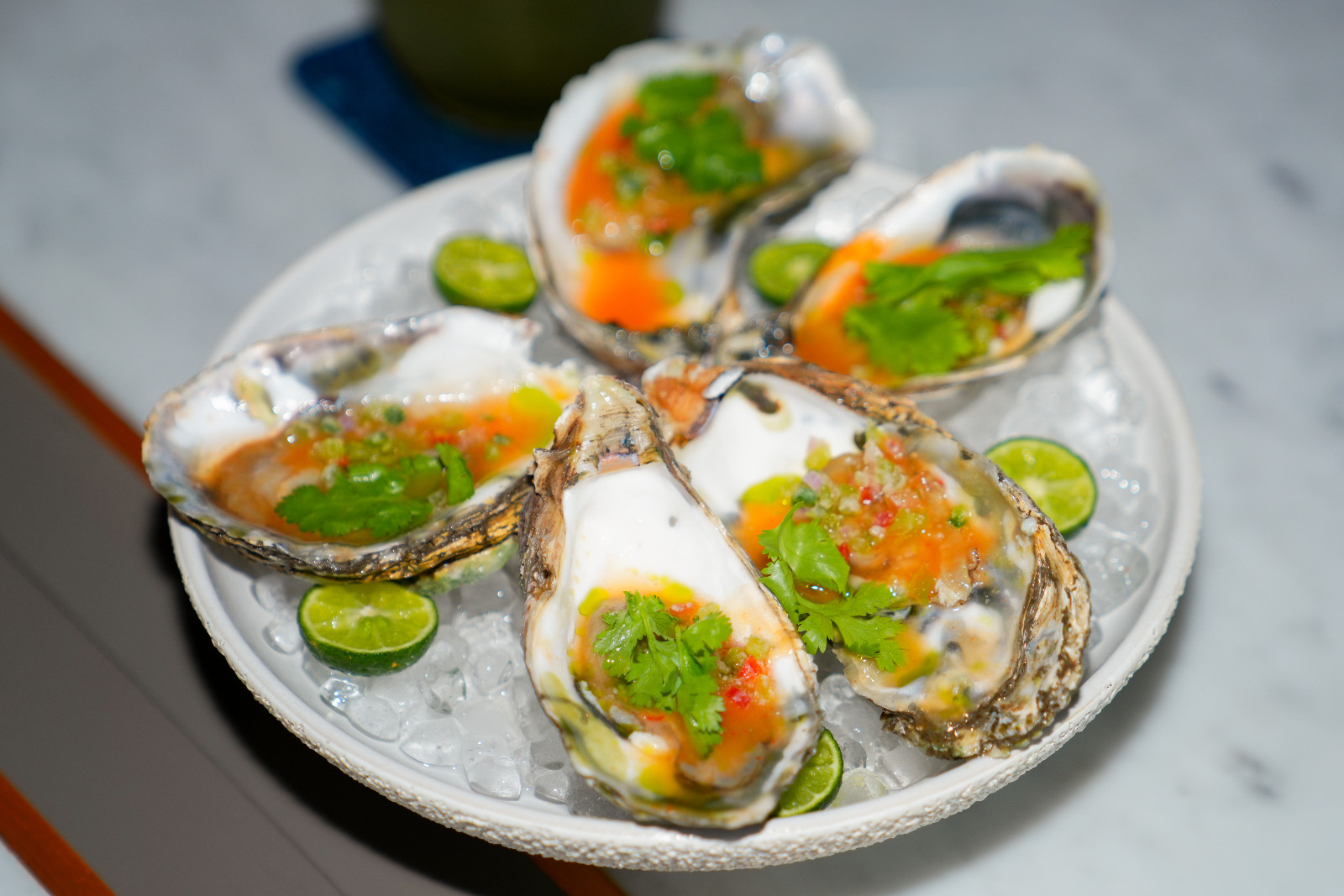 Lombok Oyster with pineapple sambal, coriander, and green oil