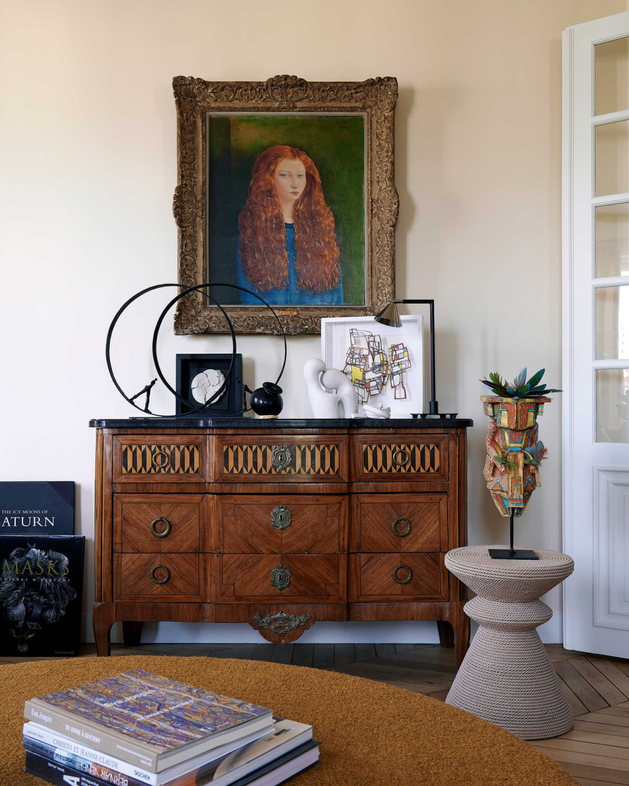 Above a Louis XVI chest of drawers, The Red-Haired Girl by Kisling sits alongside a sculpture by Nathalie Decoster