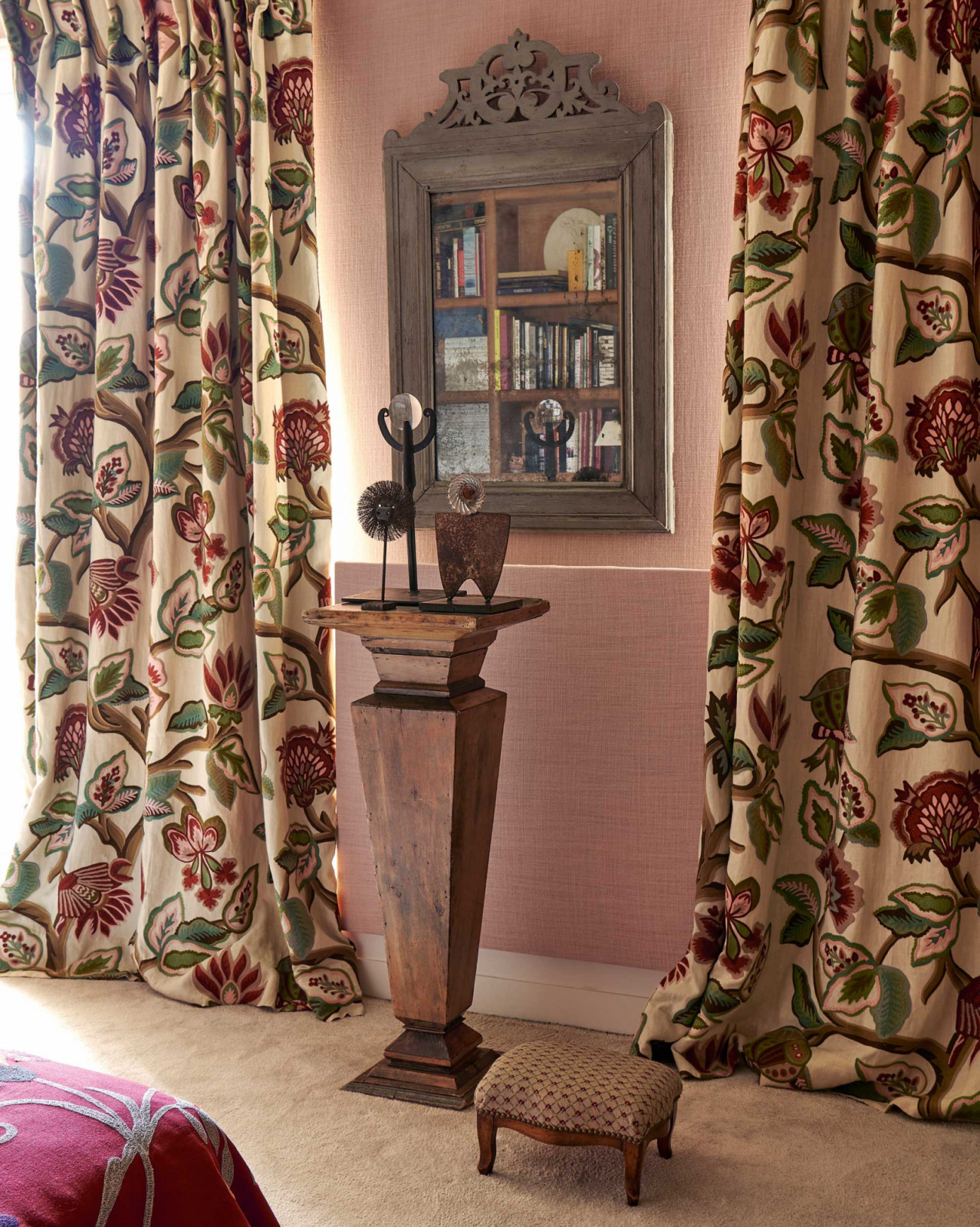 Achoka curtains by Pierre Frey flanking an antique column with sculptures by Titou Malbec and Sandrine Courau