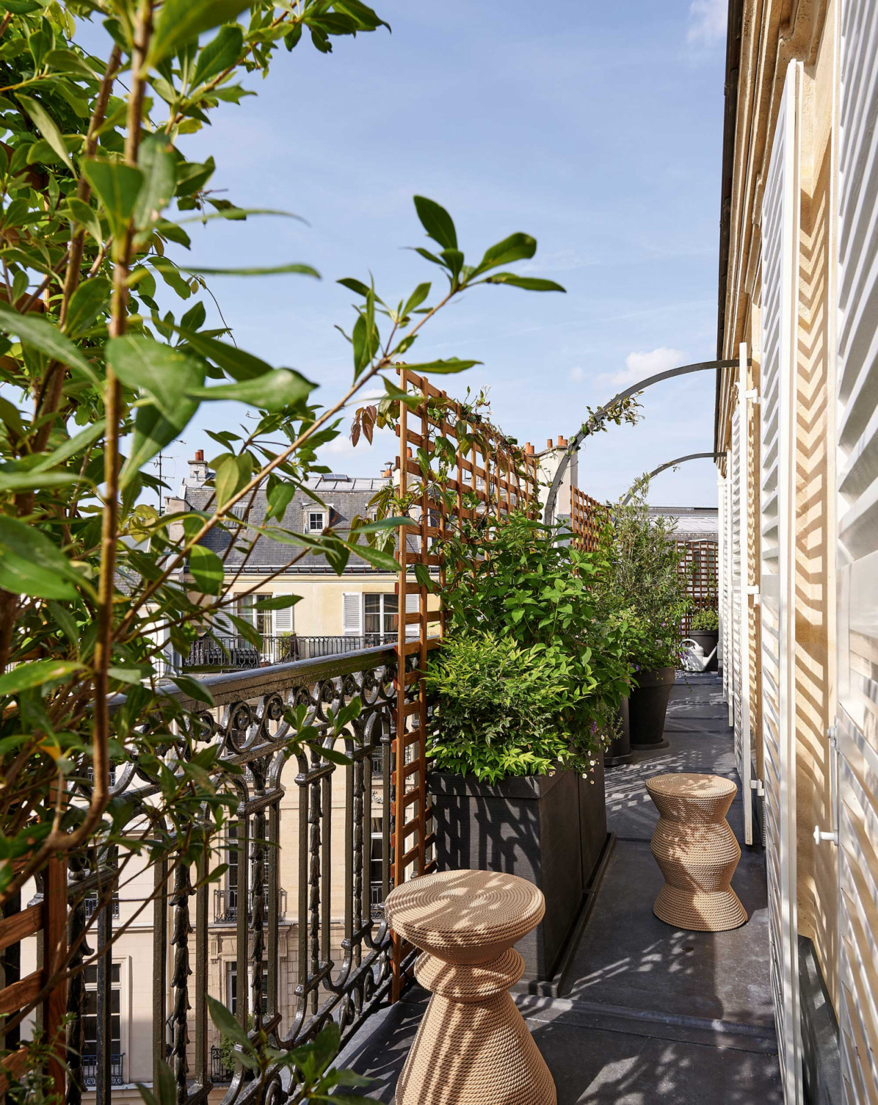 The long balcony running along the street-facing side of the apartment