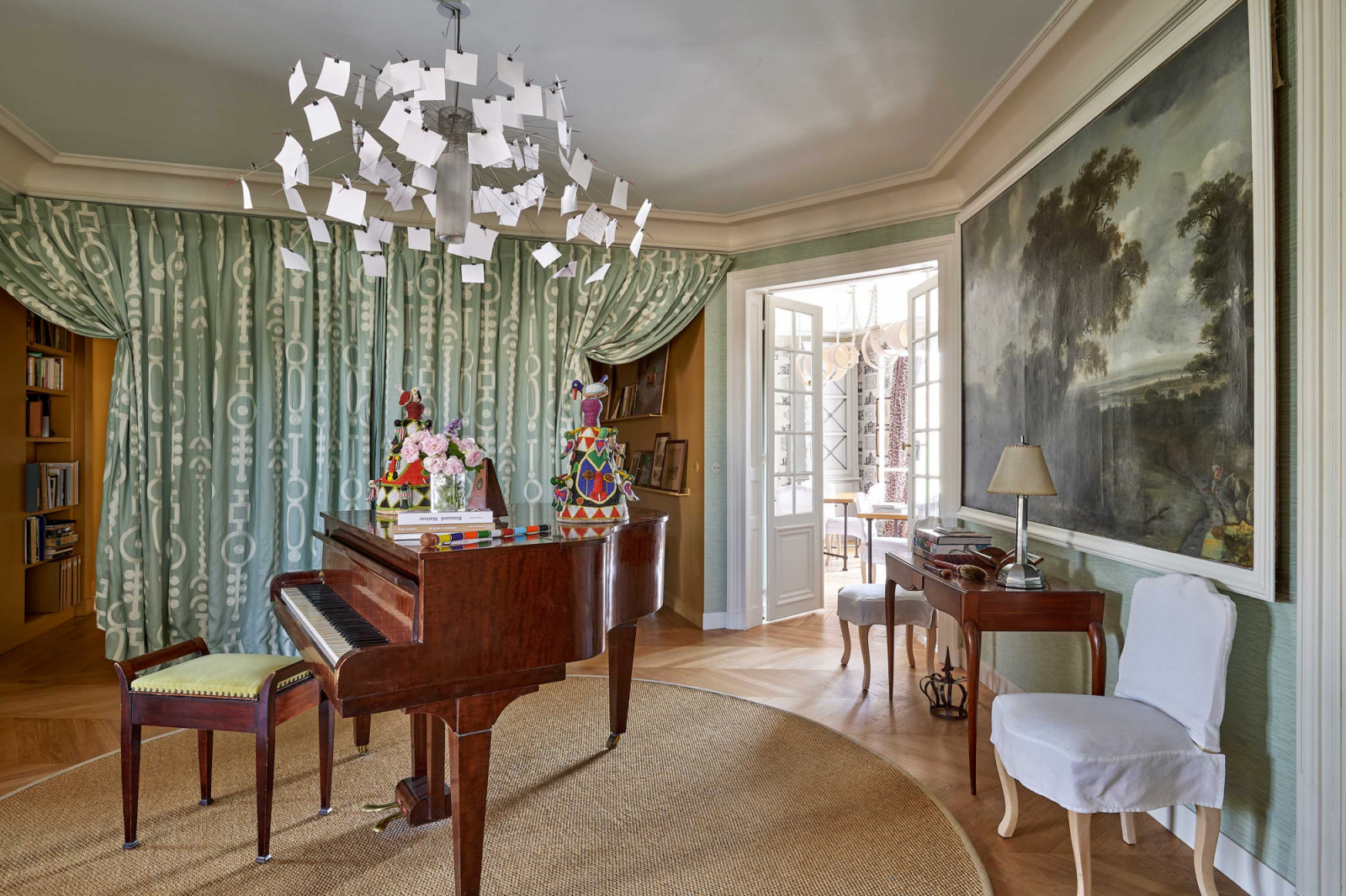 The central rotunda is the heart of the apartment’s redesigned layout, where the Ingo Maurer chandelier and Gaveau piano lend a sense of whimsy