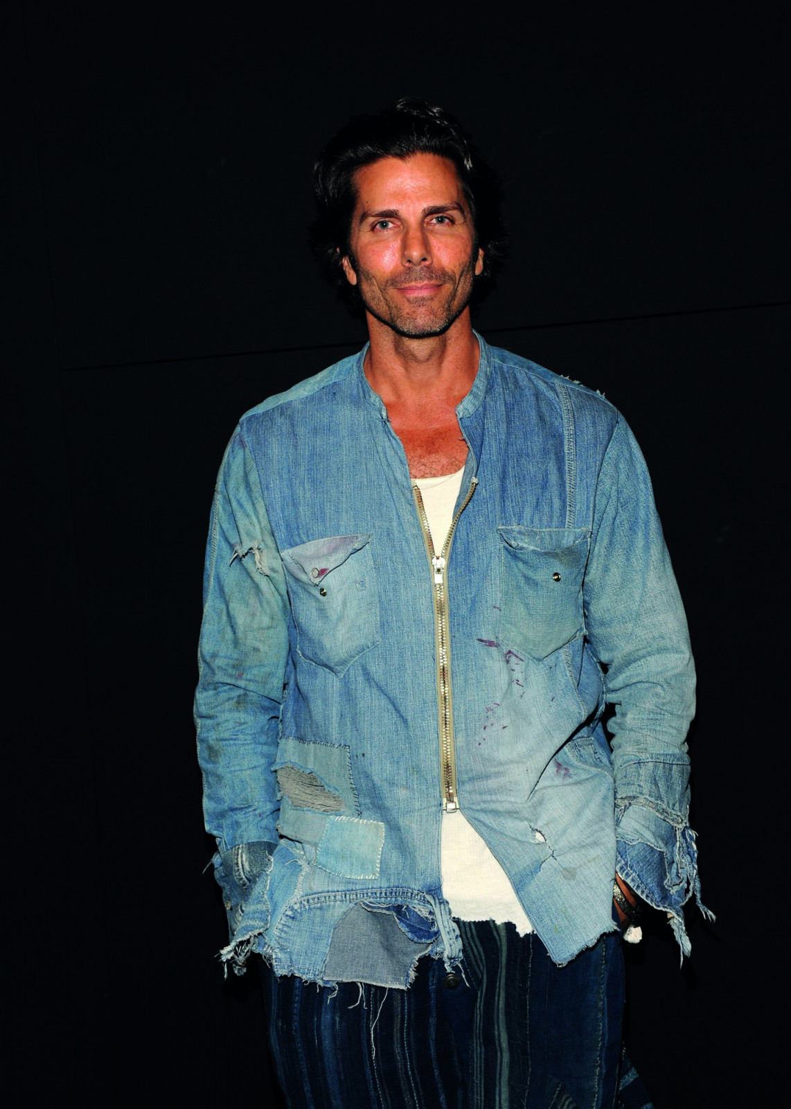 NEW YORK, NY - SEPTEMBER 16: Designer Greg Lauren poses backstage during Greg Lauren presentation Spring 2016 New York Fashion Week: The Shows at The Dock, Skylight at Moynihan Station on September 16, 2015 in New York City. (Photo by Desiree Navarro/WireImage)
