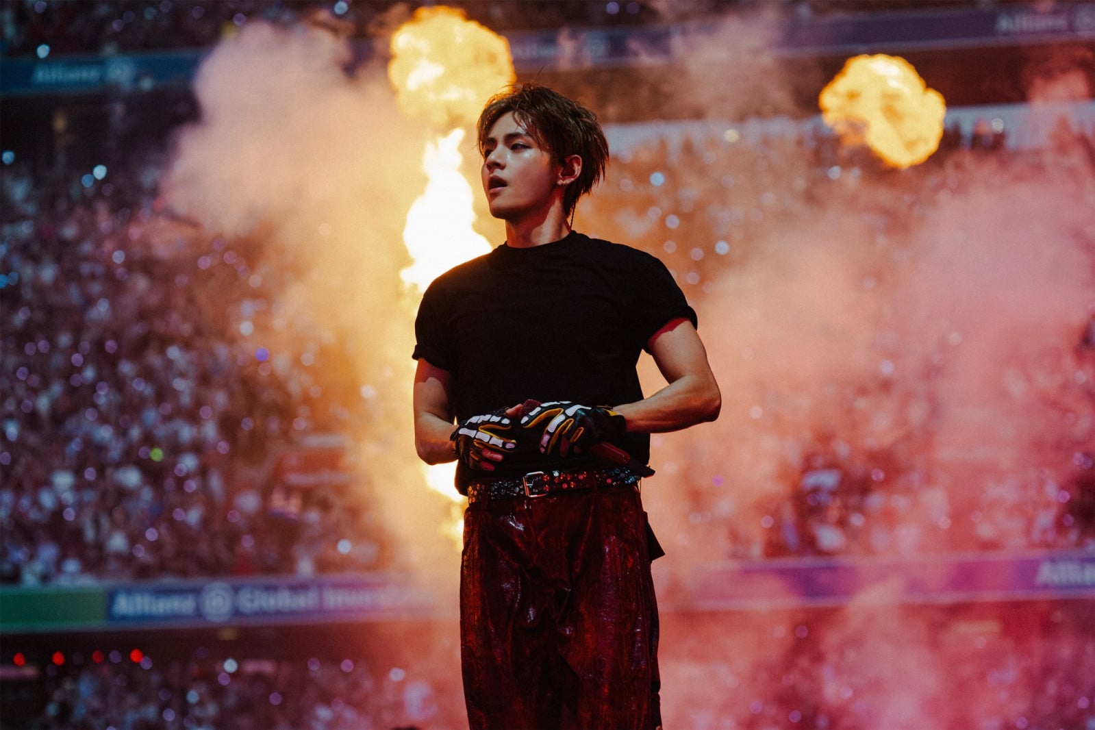 Kim Taehyung commands the stage, enveloped in a fiery display during his performance.