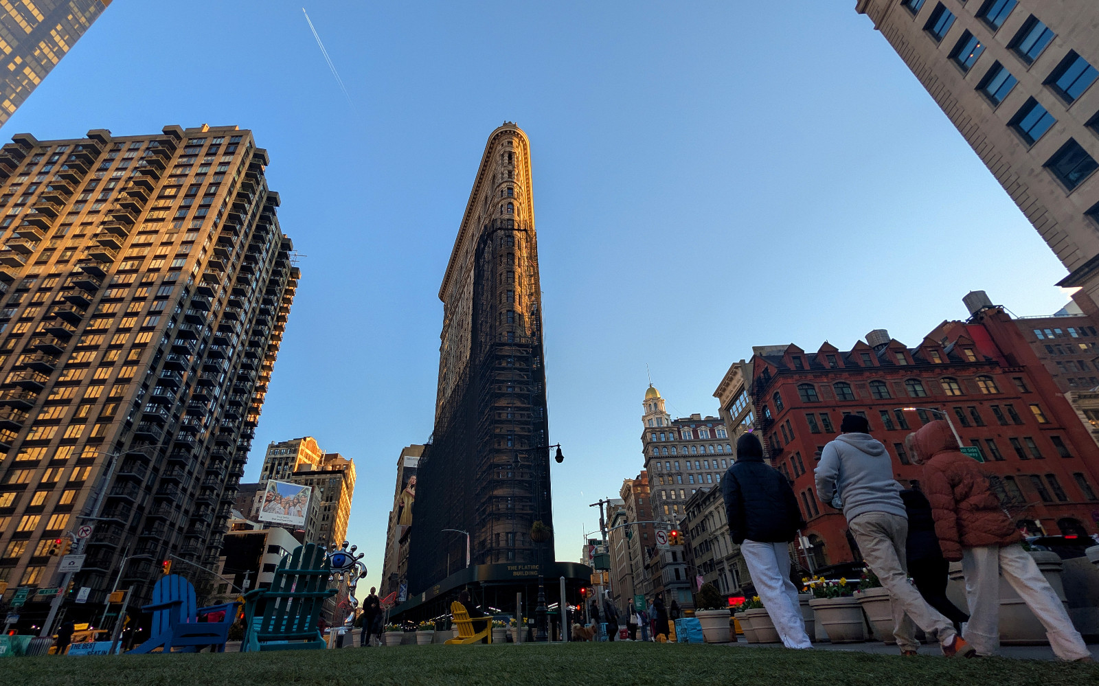 NEW YORK, NY - APRIL 8: The sun sets on the Flatiron Building as scaffolding and netting that has shrouded the facade for seven years during an office-to-residential conversion begins to be removed, on April 8, 2026, in New York City. (Photo by Gary Hershorn/Getty Images)