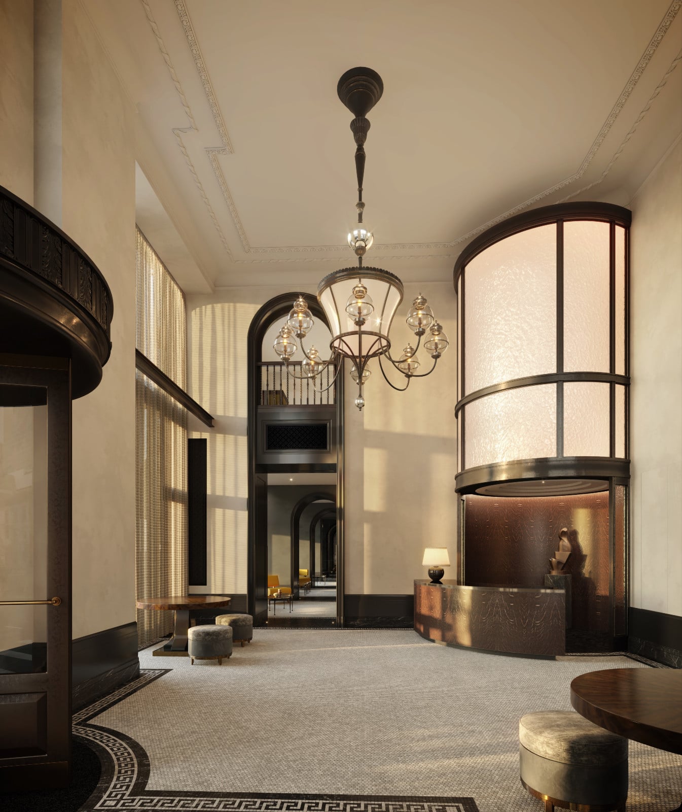 The grand entrance hall of the Flatiron Building, featuring a lavish chandelier and intricate mosaic floor.