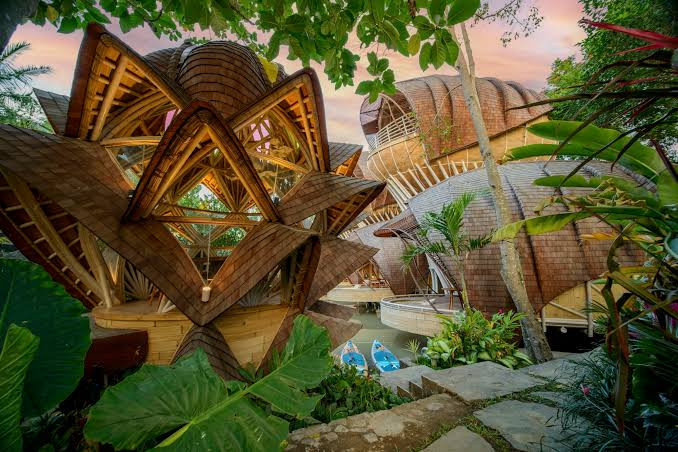 The lotus-shaped bamboo pavilion at Ulaman Eco Retreat, its faceted shingled roofs unfolding like petals around the central rooms