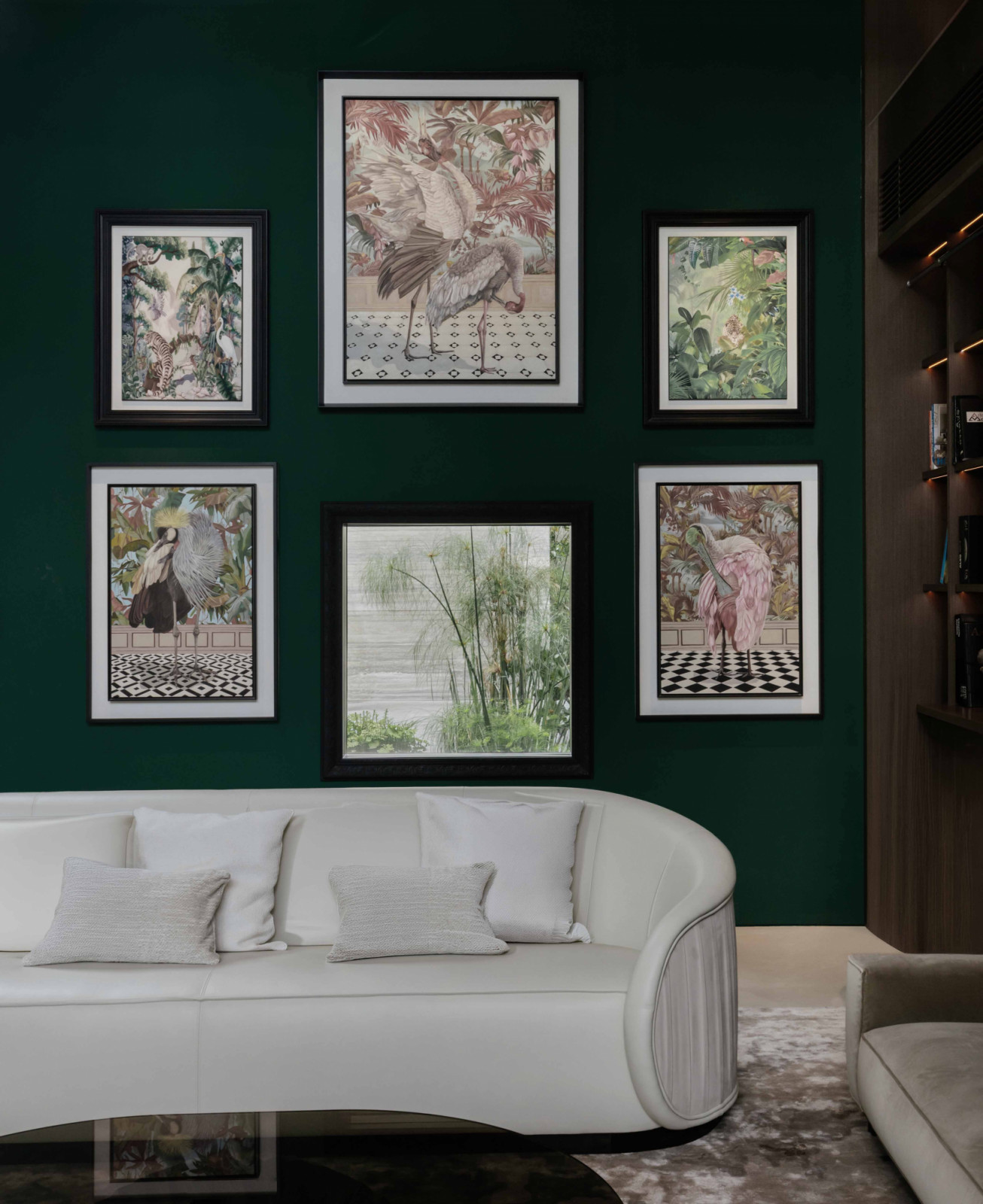 Natural history-style artworks animate the living room’s deep green wall, reinforcing the home’s botanical spirit inside the Good Class Bungalow