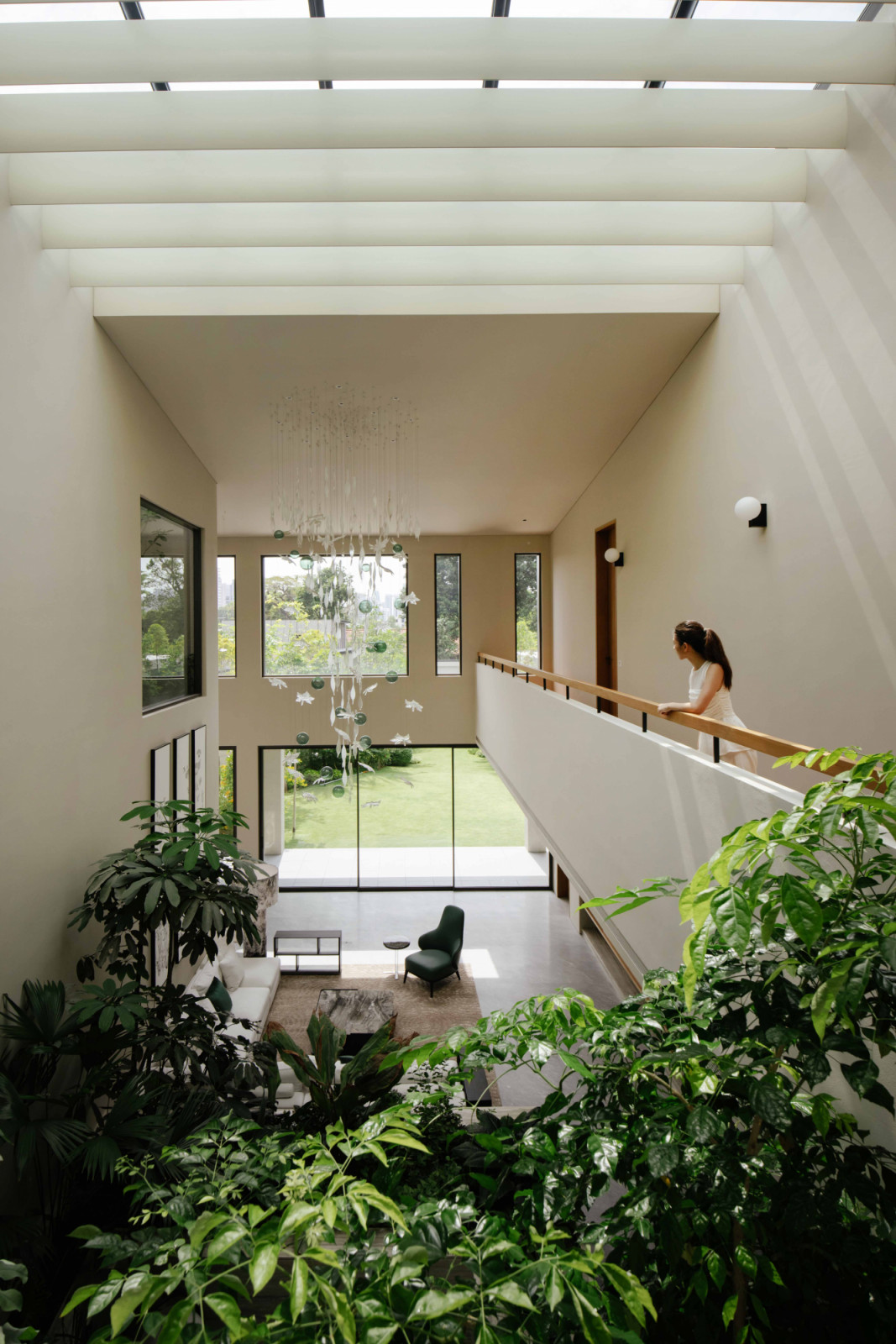 Metal fins filter daylight into the master pavilion’s double-height atrium where corridor bridges overlook the indoor garden below