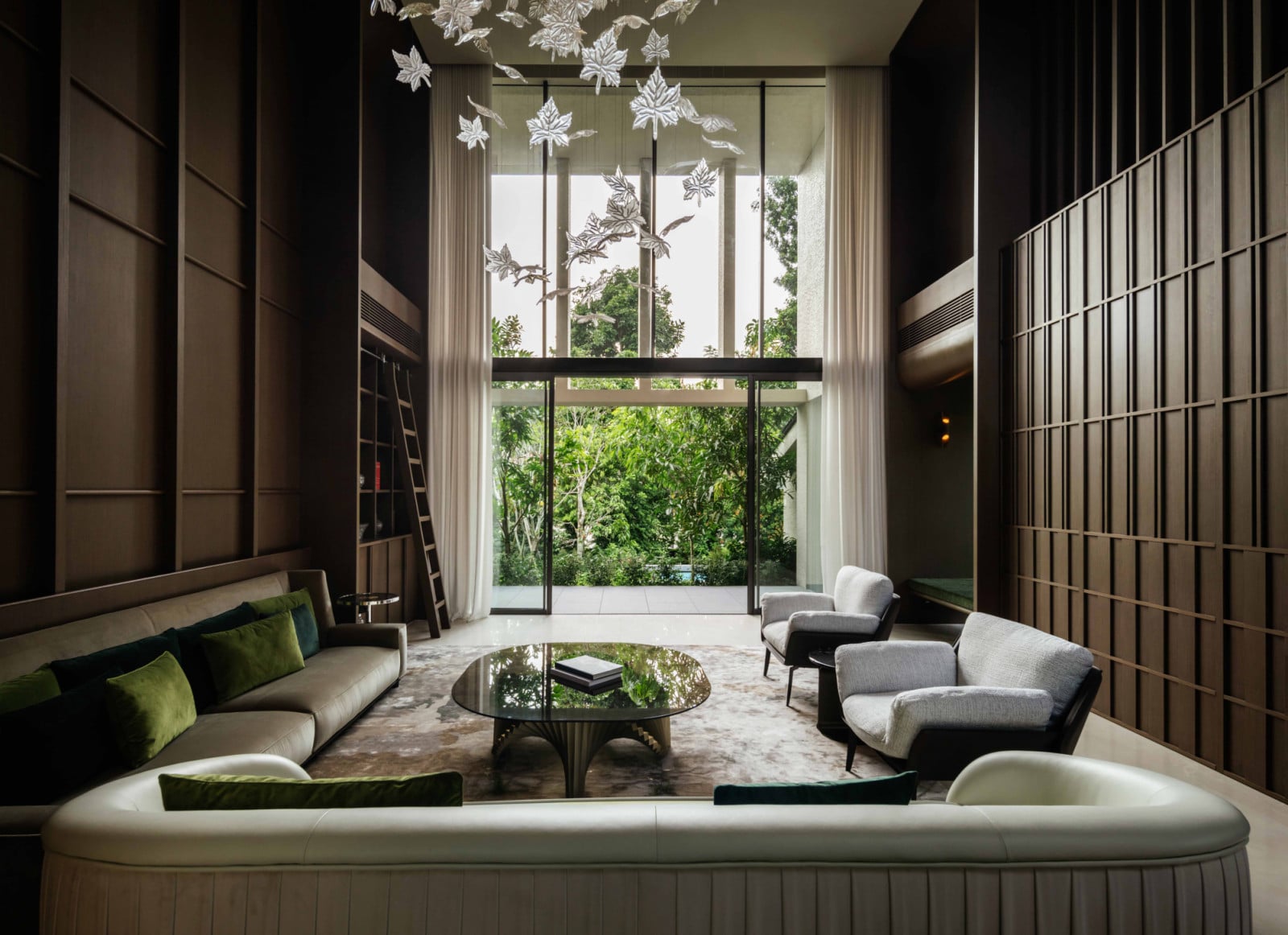 The Good Class Bungalow’s double-height living room pavilion, with timber joinery rising to the ceiling and floor-to-ceiling glazing, dissolves the boundary between interior and garden
