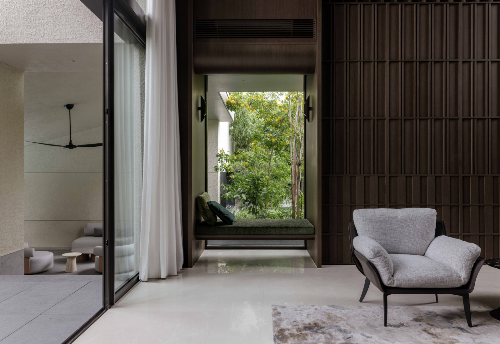 A window seat framed by Cassia fistula trees invites repose